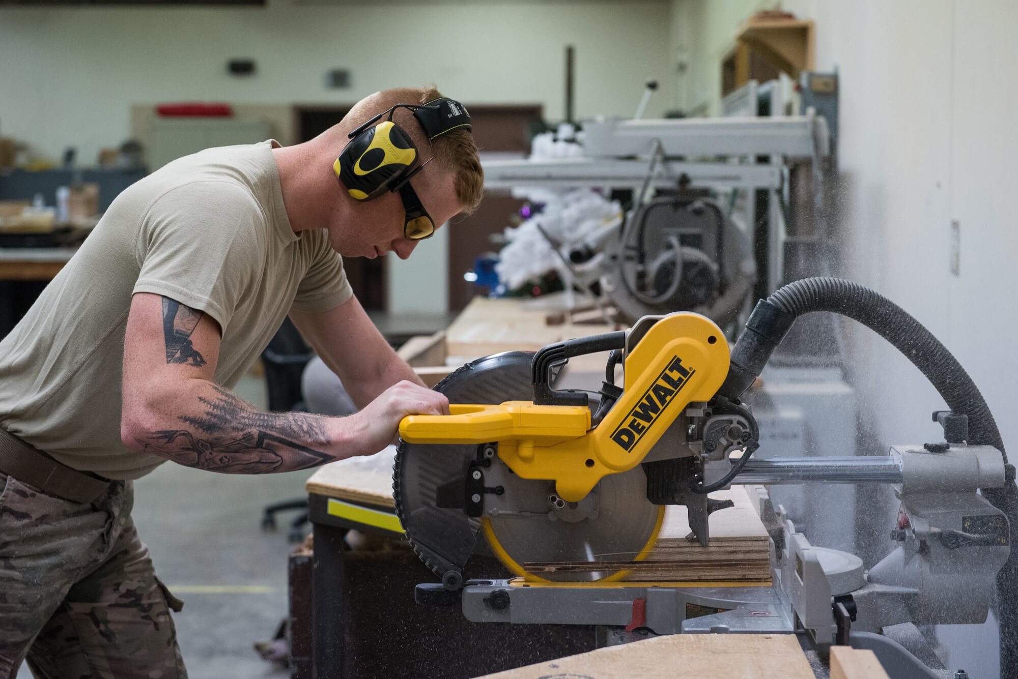 Senior Airman Dawson White, 27th Special Operations Civil Engineer Squadron structural journeyman, uses a miter saw to even out the length of different pieces of wood at Cannon Air Force Base, New Mexico, Dec. 12, 2018. Structural Airmen are able to do carpentry, metalwork, and locksmithing. (U.S. Air Force photo by Airman 1st Class Vernon R. Walter III)
