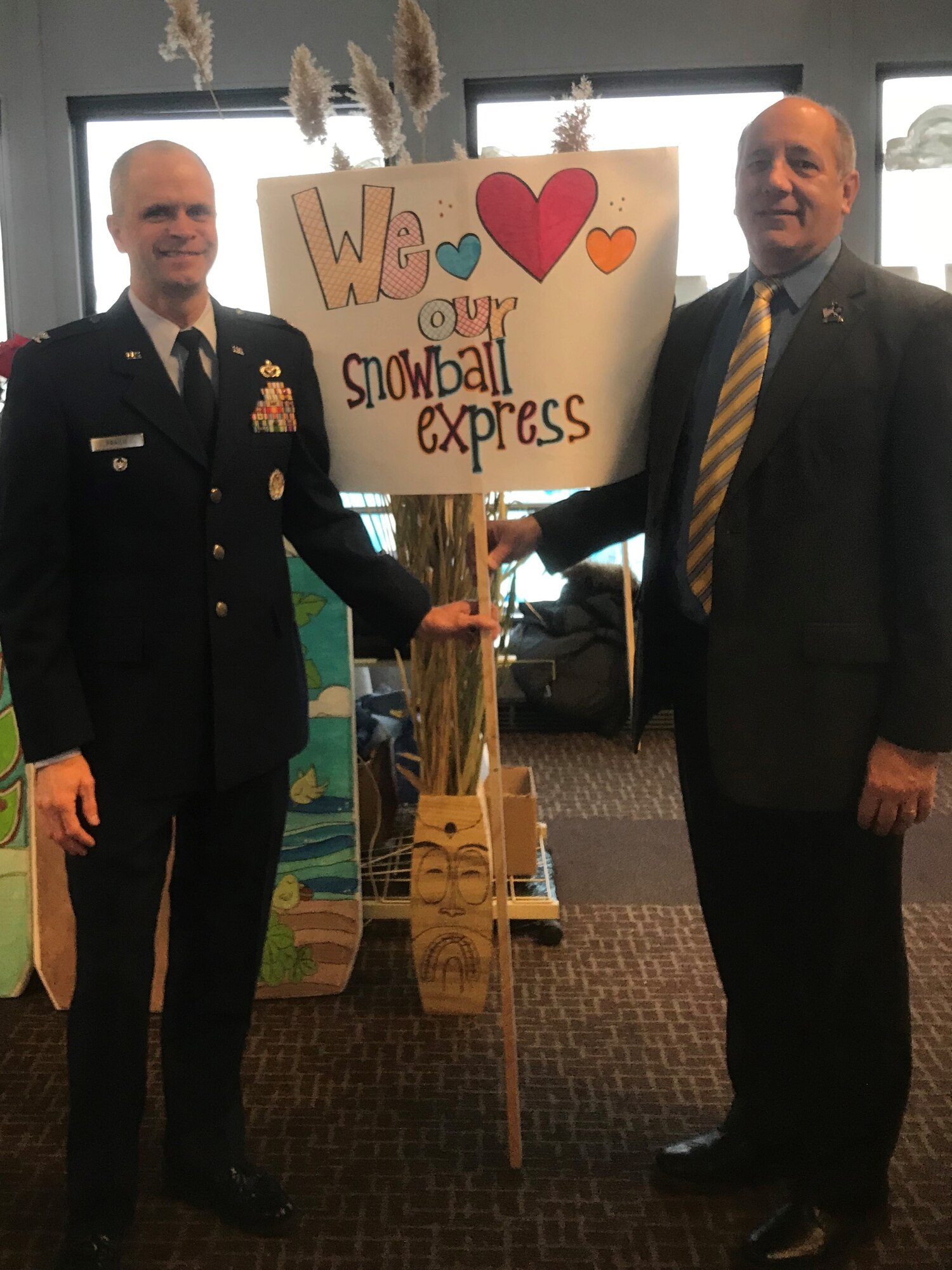 Col. Deron Frailie, 75th Air Base Wing vice commander, and Gary Harter, executive director of the Utah Department of Veterans and Military Affairs, welcome home more than 60 Utah Gold Star Families home from a Snowball Express trip to Walt Disney World Dec. 12, 2018, at Salt Lake City International Airport. (Courtesy photo by Jennifer Eaton)