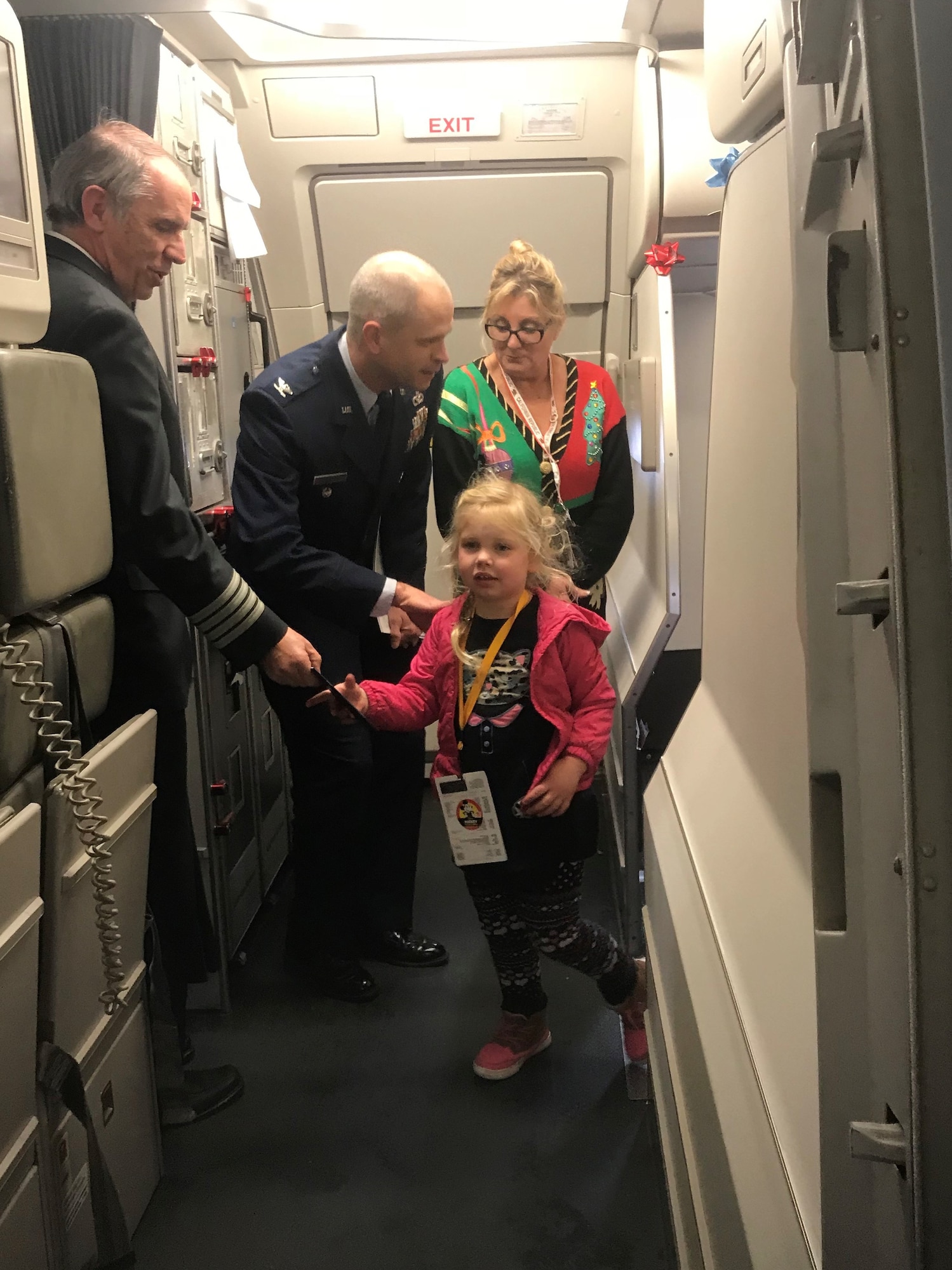 Col. Deron Frailie, 75th Air Base Wing vice commander, greets Gold Star children as they deplane from a Snowball Express trip to Walt Disney World Dec. 12, 2018, at Salt Lake City International Airport. (Courtesy photo by Jennifer Eaton)