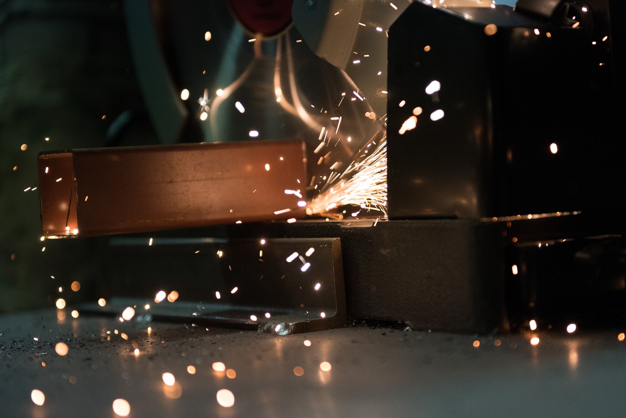 Airman 1st Class Wymond Love, 27th Special Operations Civil Engineer Squadron structural apprentice, saws a metal pipe in half with a miter saw at Cannon Air Force Base, New Mexico, Dec. 12, 2018. The career field has multiple safety precautions to prevent injuries to Airmen. (U.S. Air Force photo by Airman 1st Class Vernon R. Walter III)