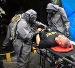 A decontamination team of Airmen and Soldiers care for casualties in a simulated mass casualty decontamination line during the 503rd Military Police Battalion field training exercise at Camp Blanding, Fla., on Oct. 24, 2018. Army Maj. Gen. William "Bill" Hall participates as a mock victim of a chemical, biological, radiological and nuclear catastrophe.