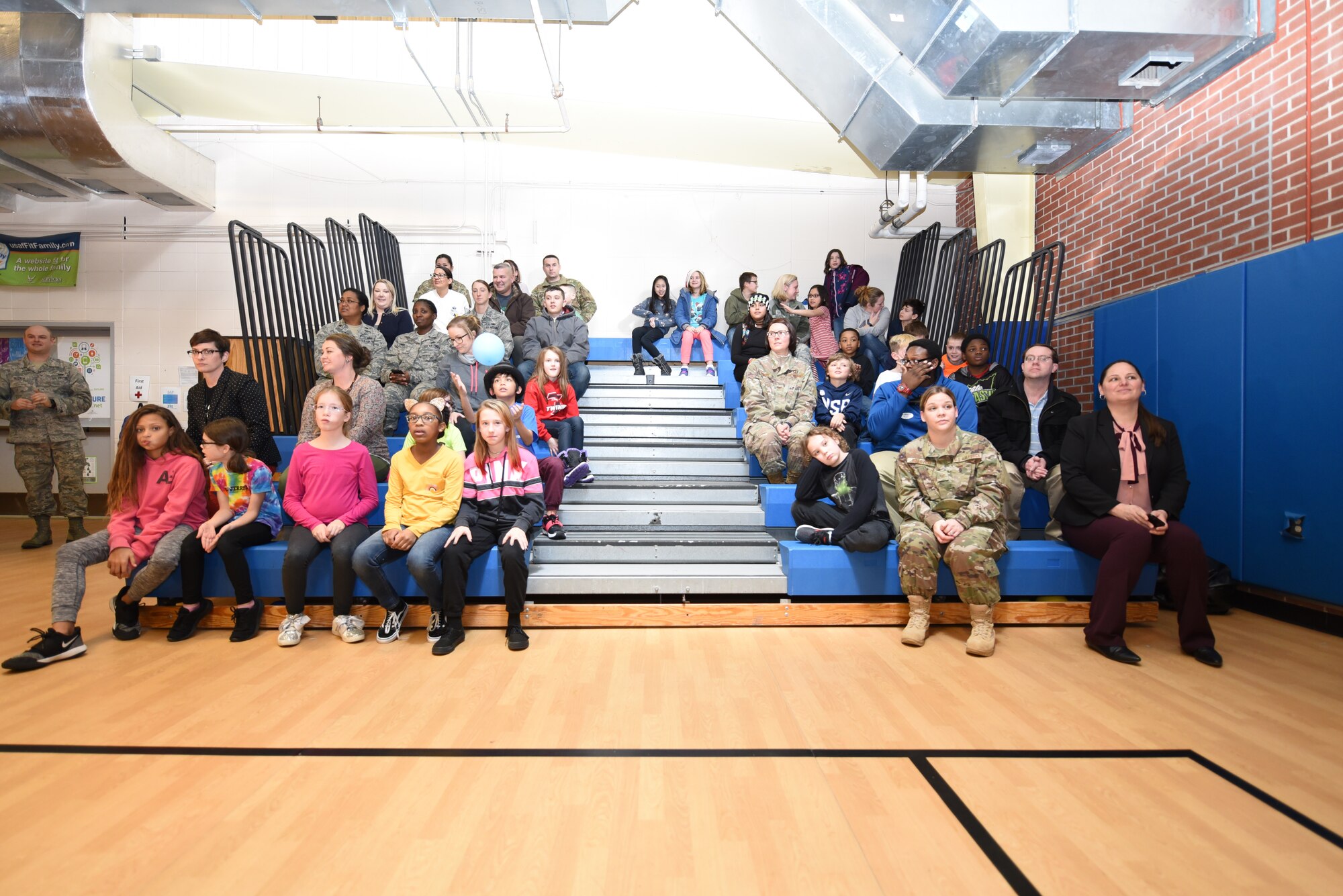Torch Club members wait for the revealing of the “Climate Superstars” prizes in the Youth Center, December 12, 2018, on Grand Forks Air Force Base, North Dakota. These members competed nationwide by completing tasks focused on themes such as improving energy, conserving water and reducing waste. (U.S. Air Force photo by Airman 1st Class Melody Wolff)