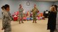 (Center) Col. Julian Cheater, 432nd Wing/432nd Air Expeditionary Wing commander, thanks Airmen volunteers at Creech Air Force Base, Nevada, for their hard work in collecting, wrapping and coordinating delivery of donated gifts for students attending Indian Springs Schools Dec. 14, 2018. Kimberly Guerino, Indian Springs Schools registrar, and Kelly Miles, Indian Springs Schools counselor, accepted the gifts on behalf of their students. (U.S. Air Force photo by Tech. Sgt. Dillon White)