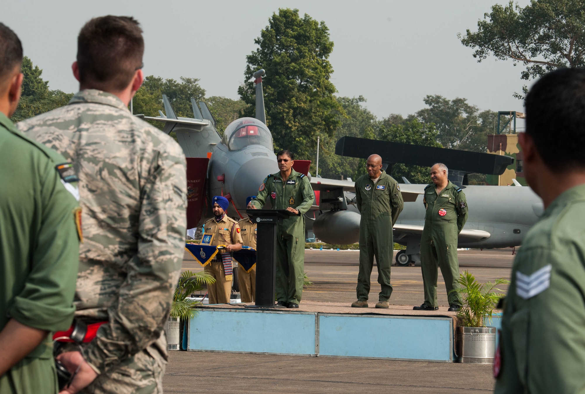 Indian Air Force Air Commodore Saji Anthony, IAF air officer commanding, says a few words and introduces U.S. Air Force Gen. CQ Brown, Jr., Pacific Air Forces commander, and IAF Air Marshal Raghunath Nambiar, air officer commanding commanding-in-chief, Eastern Air Command, at the closing ceremony of Cope India 19 at Kalaikunda Air Force Station, India, Dec. 14, 2018.