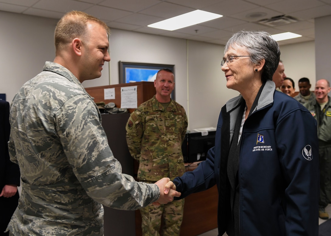 U.S. Air Force Capt. Greg Hoyt, 1st Maintenance Squadron Fabrication Flight commander, greets Air Force Secretary Heather Wilson at Joint Base Langley-Eustis, Virginia, Dec. 12, 2018.