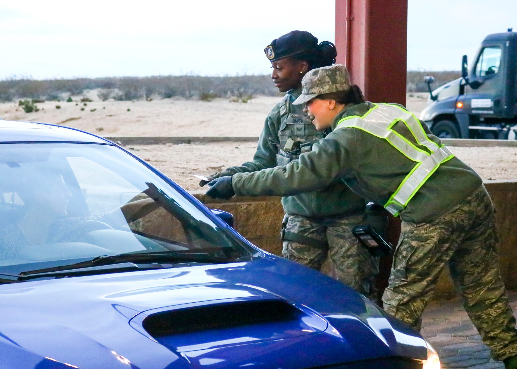 Lt. Col. Neva Vanderschaegen, 412th Medical Support Squadron commander, hands out candy canes to a Team Edwards member at Edwards Air Force Base, California, Dec. 17. (U.S. Air Force photo by Giancarlo Casem)