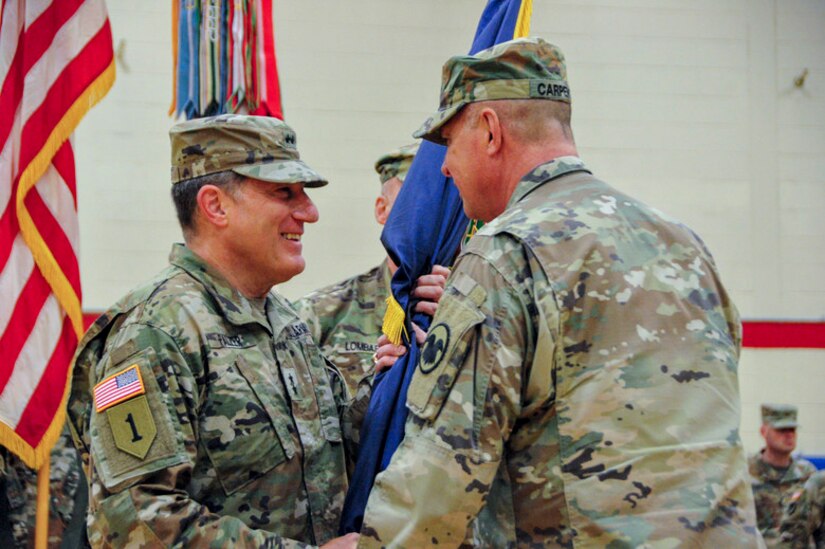 Maj. Gen. Scottie Carpenter, the Deputy Commanding General of U.S. Army Reserve Command, passes the colors to Maj. Gen. Mark W. Palzer during the 99th Readiness Division change of command ceremony, Dec. 16 at Doughboy Gym, on Joint Base McGuire-Dix-Lakehurst, New Jersey. As commanding general of the 99th DIV(R), Palzer is responsible for administrative, logistics and facilities support to more than 42,000 U.S. Army Reserve Soldiers across a region spanning the thirteen northeastern states. He also serves as the senior commander of Army Support Activity-Fort Dix and U.S. Army Base Fort Devens Training Facilities and Training Support in Massachusetts.