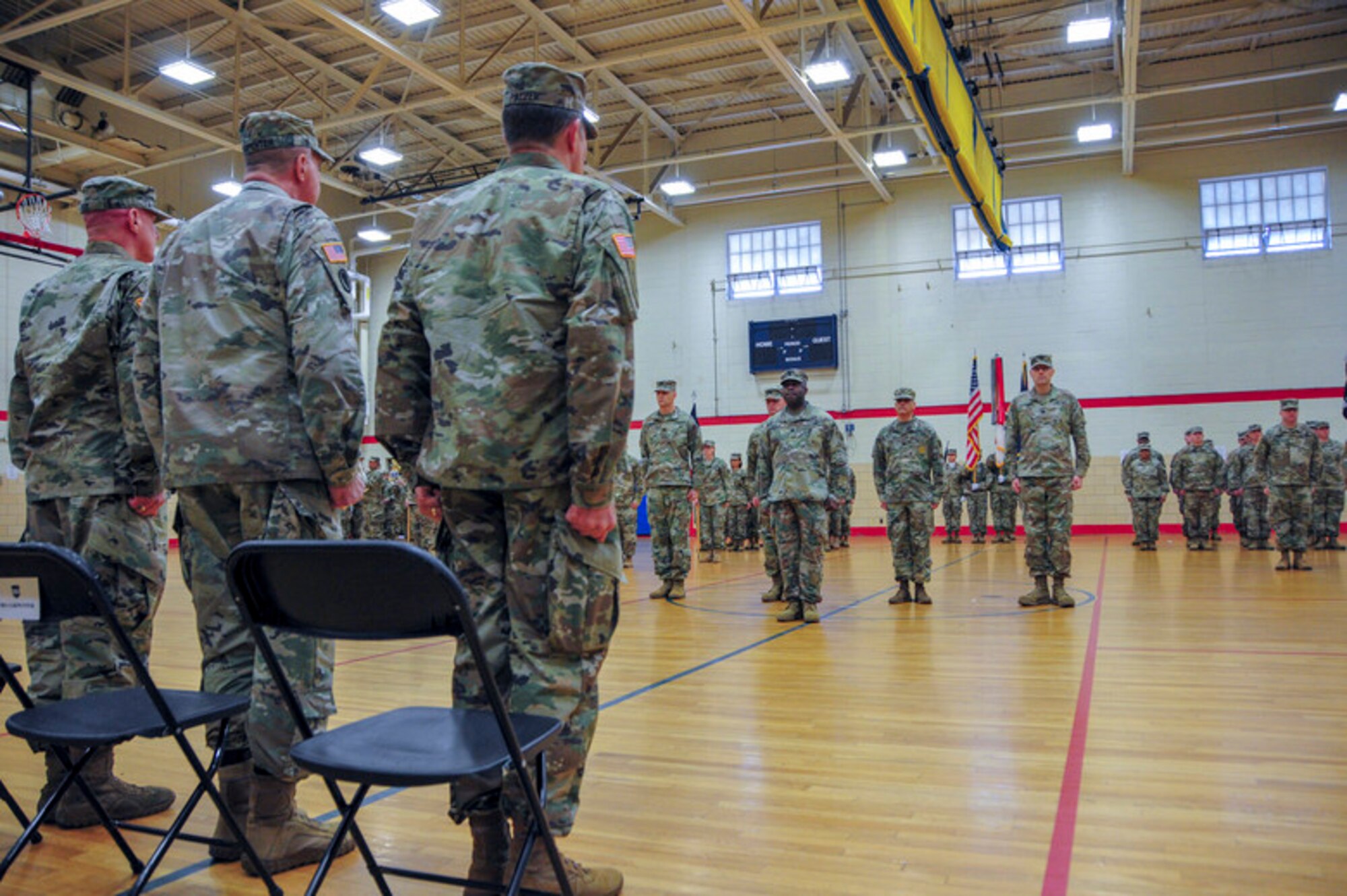From right to left) Maj. Gen. Mark W. Palzer, the incoming commanding general,  Maj. Gen. Scottie Carpenter, the Deputy Commanding General of U.S. Army Reserve Command, and  Maj. Gen. Troy D. Kok, the outgoing commanding general stand at attention during the 99th Readiness Division change of command ceremony, Dec. 16 at Doughboy Gym, on Joint Base McGuire-Dix-Lakehurst, New Jersey. Both Kok and Palzer are New Jersey natives, the former having grown up in the Allentown area and the latter a current resident of Jackson.