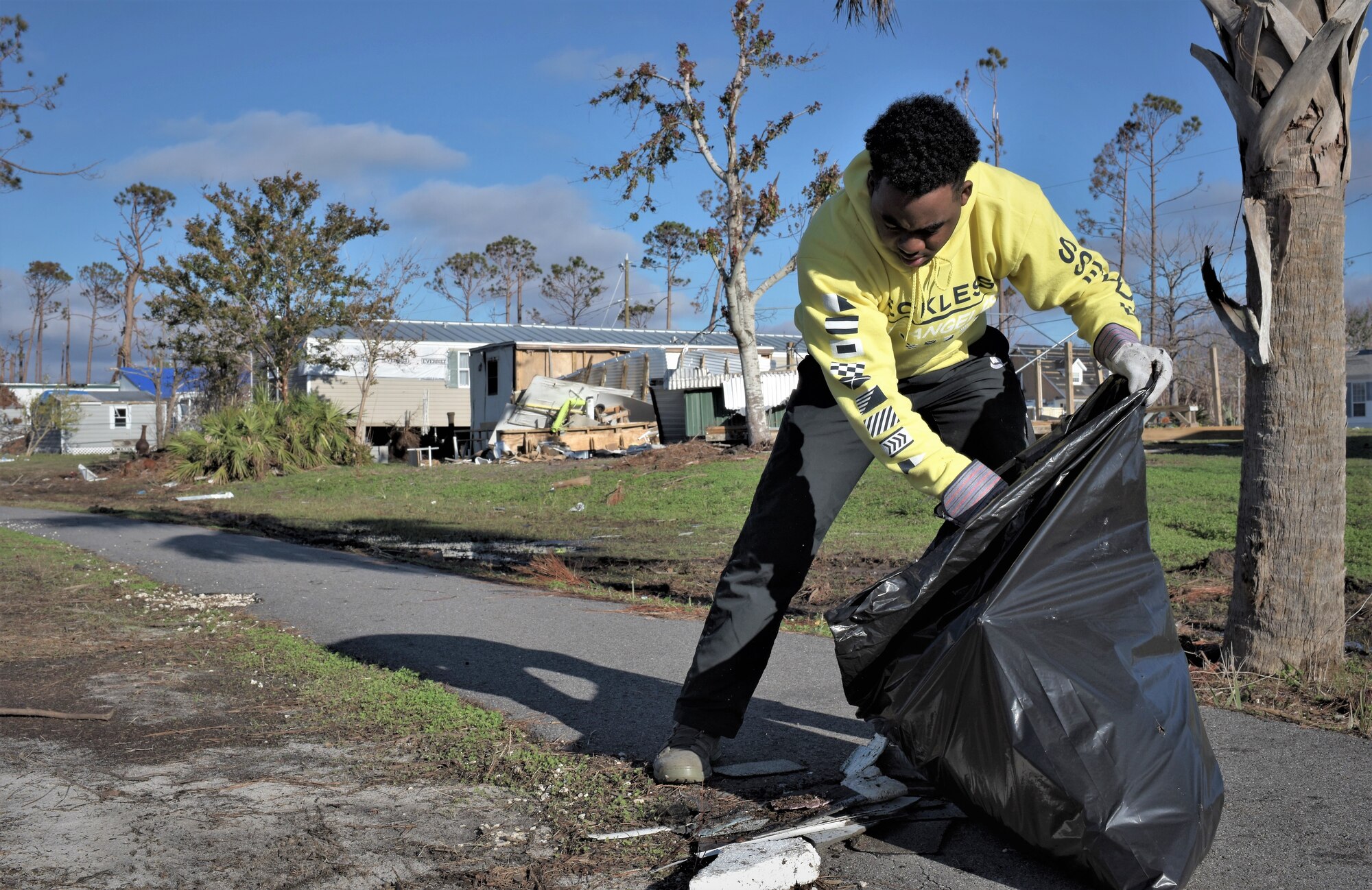 Airman 1st Class Tristain Blaney, 325th Force Support Squadron, Fitness Assessment Cell trainee, helps clean Under the Palms Park in Mexico Beach, Fla., Dec. 16, 2018. Thirty nine volunteers from Tyndall and Eglin Air Force Bases came together to help clean Mexico Beach, one of the communities hit the hardest by Hurricane Michael.  The volunteers were able to clean up more than 40 cubic yards of debris within four hours. (U.S. Air Force photo by Tech. Sgt. Sara Keller)