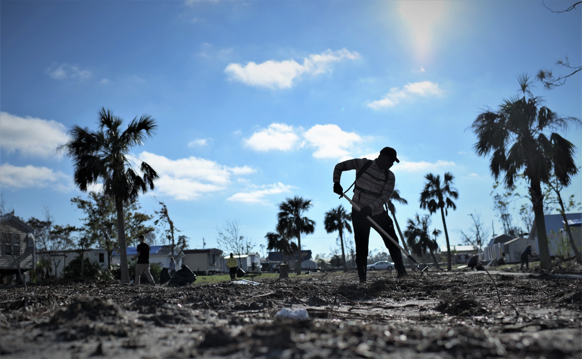 An Airman from Tyndall Air Force Base cleans debris from Under the Palms Park in Mexico Beach, Fla., Dec. 16, 2018. Thirty nine volunteers from Tyndall and Eglin Air Force Bases came together to help clean Mexico Beach, one of the communities hit the hardest by Hurricane Michael.  The volunteers were able to clean up more than 40 cubic yards of debris within four hours. (U.S. Air Force photo by Tech. Sgt. Sara Keller)