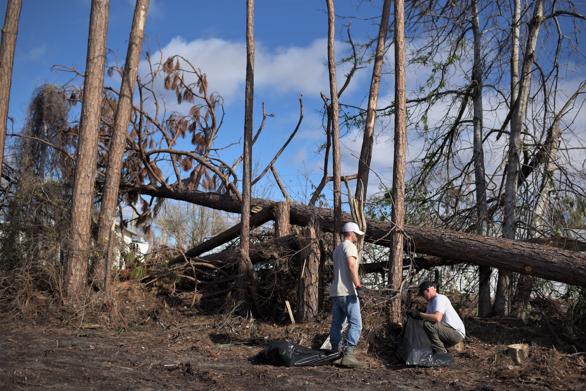 Two volunteers from Tyndall Air Force Base clean debris from Under the Palms Park in Mexico Beach, Fla., Dec. 16, 2018. Thirty nine volunteers from Tyndall and Eglin Air Force Bases came together to help clean of Mexico Beach, one of the communities hit the hardest by Hurricane Michael.  The volunteers were able to clean up more than 40 cubic yards of debris within four hours. (U.S. Air Force photo by Tech. Sgt. Sara Keller)