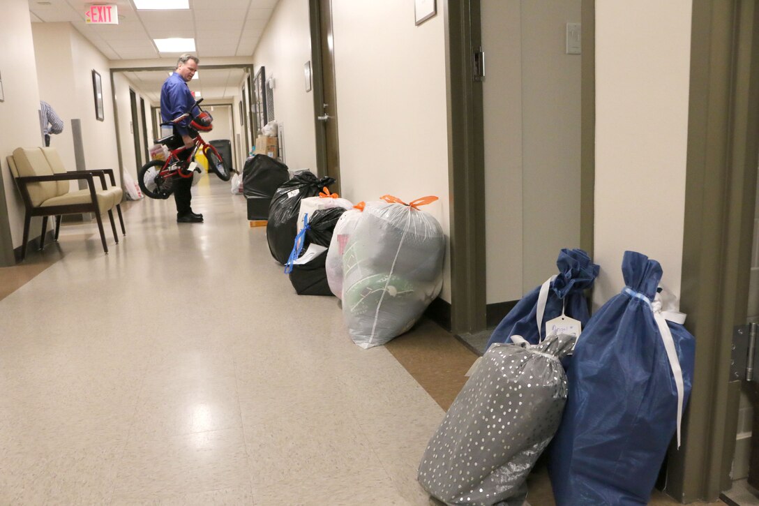 Joseph Sheeley seeks out a space in a hallway in the Arnold Air Force Base Medical Aid Station to place a bicycle purchased for the 2018 AEDC Angel Tree program. This year, all 140 children on the Angel Tree list provided to Arnold Air Force Base were sponsored. (U.S. Air Force photo by Bradley Hicks)