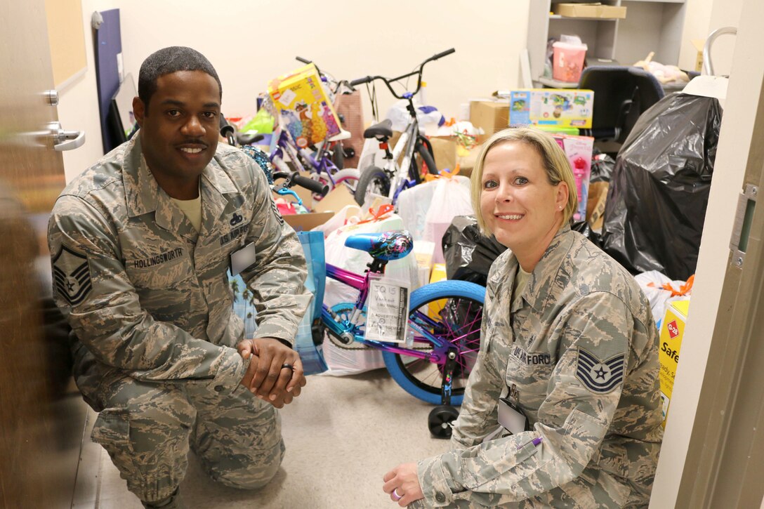 Master Sgt. Ricardo Hollingsworth, left, and Tech Sgt. Beverly Spademan display gifts for the 2018 AEDC Angel Tree program. Hollingsworth and Spademan coordinated this year’s program, which was deemed a success as all 140 children on the Angel Tree list provided to Arnold Air Force Base were sponsored. (U.S. Air Force photo by Bradley Hicks) (This image was altered by obscuring badges for security purposes)