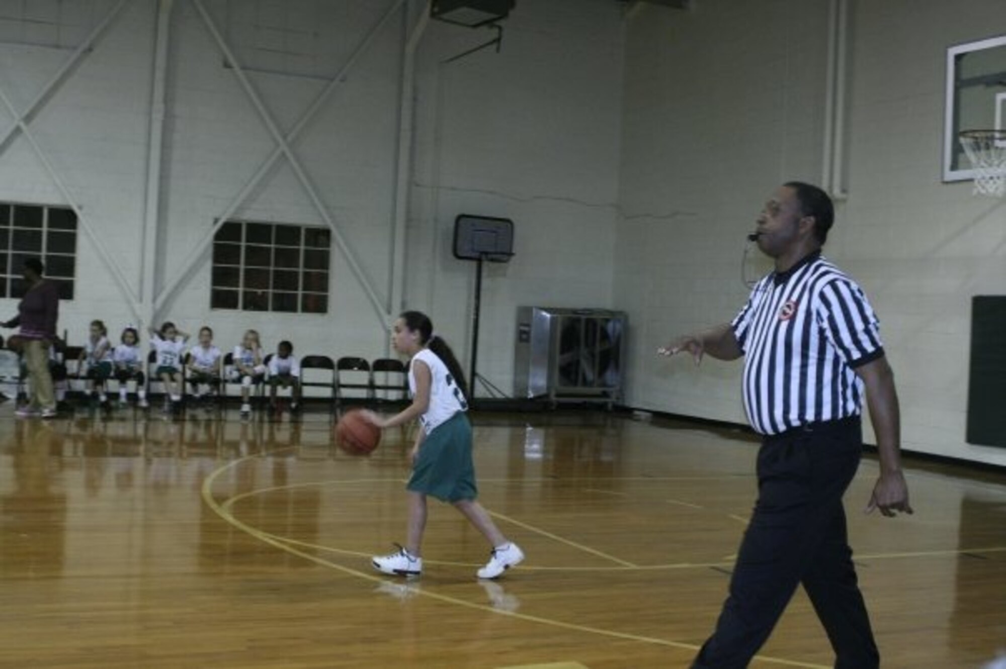 Maverick Mosley, a journeyman boilermaker who has been employed at Arnold for 39 years, keeps his whistle at the ready while officiating a local basketball game. Mosley is one of several Arnold employees who also works as sports officials. (Photo by Andrea Stephens)