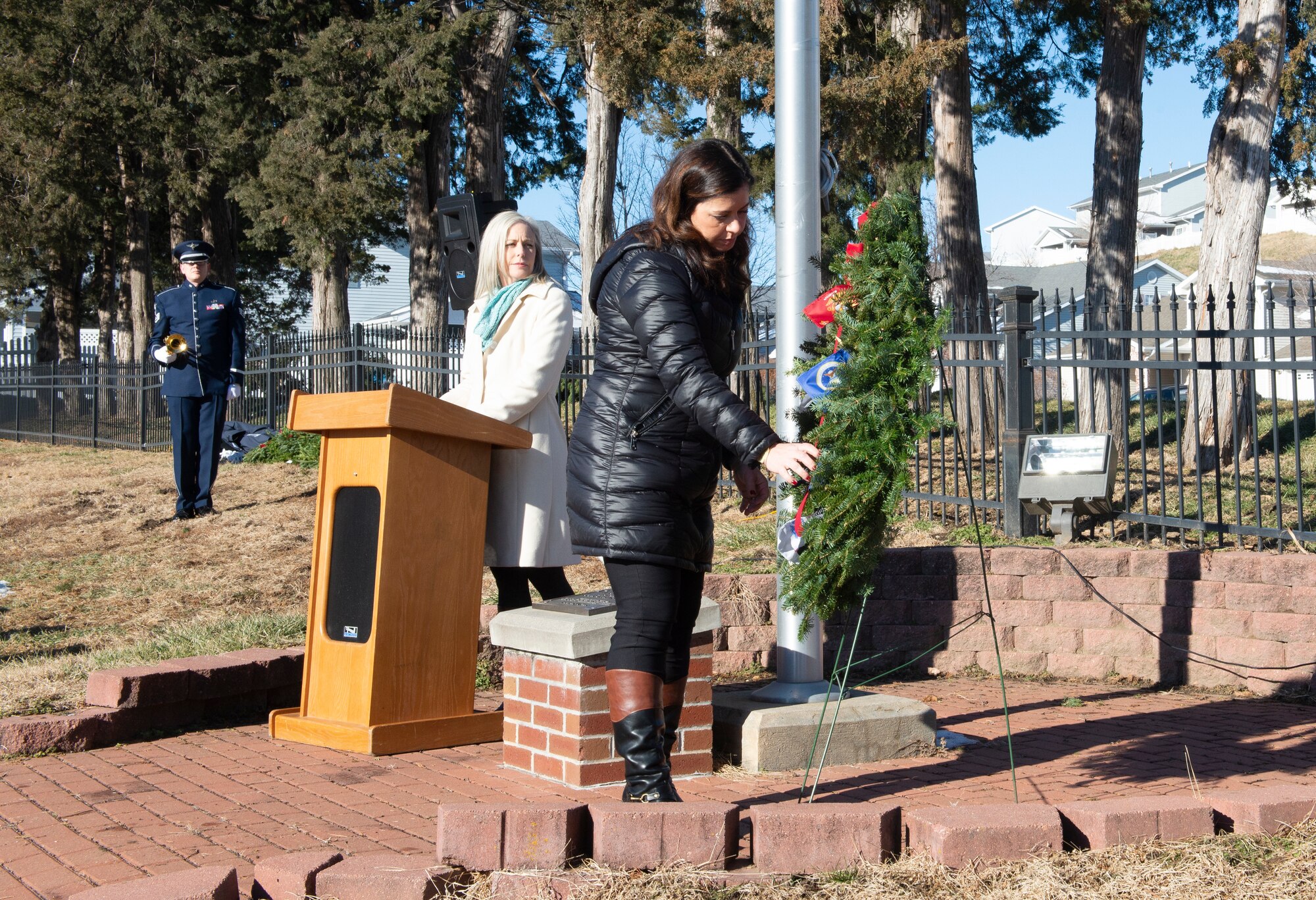 Elizabeth Phillips, wife of Major Nick Phillips, 1st Air Combat Command Squadron, places a wreath during the National Wreaths Across America ceremony Dec. 15, 2018, at the Offutt Air Force Base Cemetery, Nebraska. Phillips, a member of the Offutt Officers Spouses’ Club was one of the members who initiated the instatement of Offutt AFB Cemetery into Wreaths Across America organization. (U.S. Air Force photo by L. Cunningham)