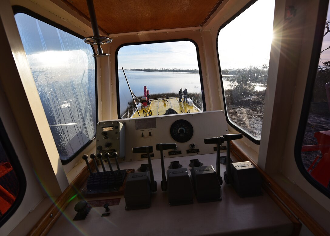 A beached U.S. Air Force Missile Retriever Ship is inspected by Sailors, Airmen and contractors as they stand on the deck of the vessel near Tyndall Air Force Base, Fla., Dec. 12, 2018. The vessel belongs to the 53rd Weapons Evaluation Group. Sailors from Mobile Diving and Salvage Unit (MDSU) 2, homeported at Joint Expeditionary Base Little Creek-Ft. Story, partnered with Tyndall personnel to return the vessel to the water. The Missile Retriever ship is responsible for the location and recovery of Subscale Aerial Targets in the Gulf of Mexico W151 Live-Fire Range. MR’s also conduct launch and recovery corridor clearance operations for both SSAT and Fullscale Aerial Target Missions. (U.S. Air Force photo by Senior Airman Isaiah J. Soliz)