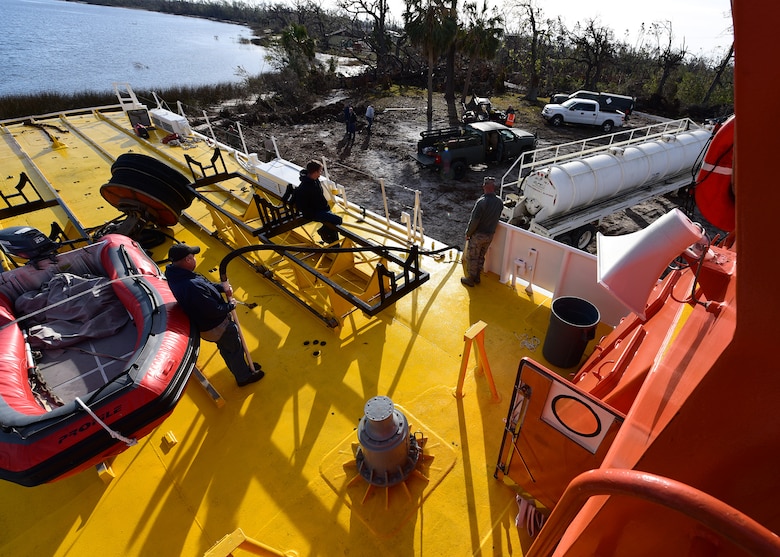 A beached U.S. Air Force Missile Retriever Ship is defueled near Tyndall Air Force Base, Fla., Dec. 12, 2018. The strong winds of Hurricane Michael caused the vessel to run aground over two months ago. The vessel had to be defueled prior to being returned to the water. (U.S. Air Force photo by Senior Airman Isaiah J. Soliz)