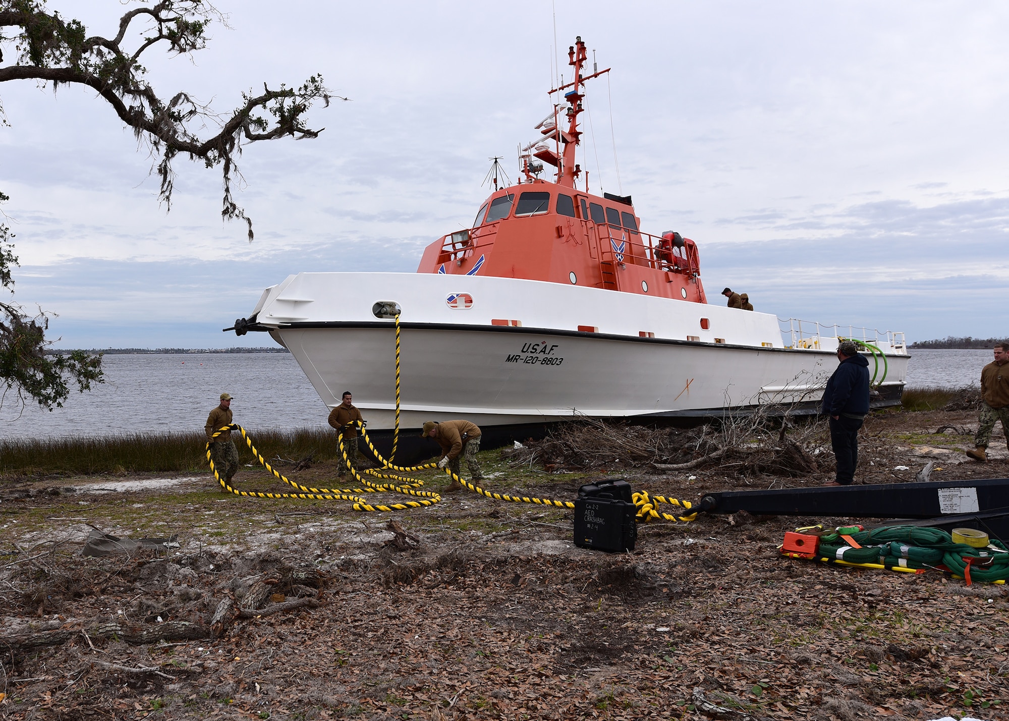 U.S. Navy Sailors attach a guiding line to an anchor prior to returning a beached vessel to the water while at Tyndall Air Force Base, Fla., Dec. 13, 2018. The U.S. Air Force Missile Retriever Ship was beached during the strong winds of Hurricane Michael. Sailors from Mobile Diving and Salvage Unit (MDSU) 2, homeported at Joint Expeditionary Base Little Creek-Ft. Story, partnered with Tyndall personnel to return the vessel to the water. The Missile Retriever ship is responsible for the location and recovery of Subscale Aerial Targets in the Gulf of Mexico W151 Live-Fire Range. MR’s also conduct launch and recovery corridor clearance operations for both SSAT and Full-scale Aerial Target Missions. (U.S. Air Force photo by Senior Airman Isaiah J. Soliz)