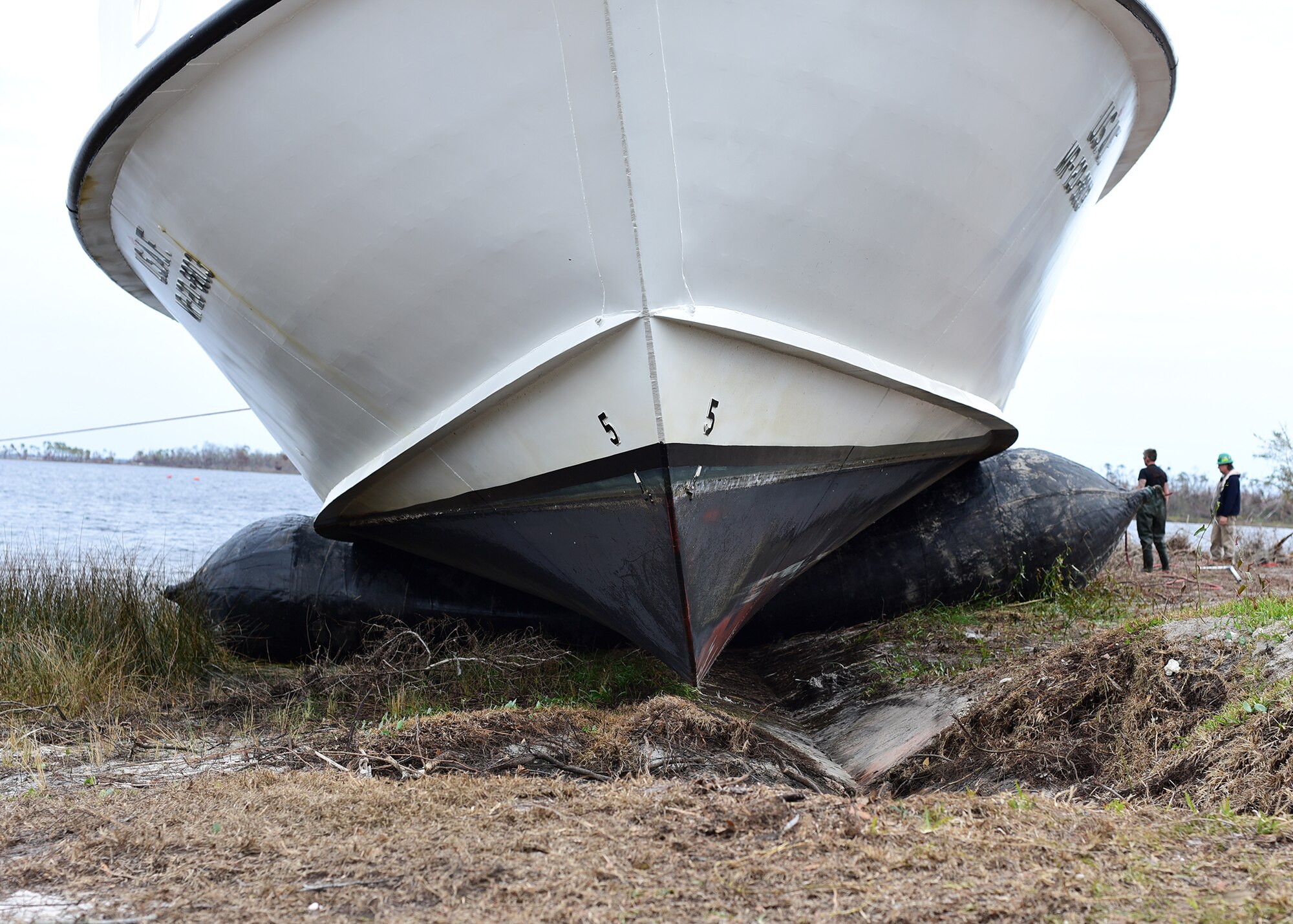 A beached U.S. Air Force Missile Retriever Ship is raised from the ground by inflatable bladders near Tyndall Air Force Base, Fla., Dec. 13, 2018. The strong winds of Hurricane Michael caused the vessel to run aground over two months ago. The Missile Retriever ship is responsible for the location and recovery of Subscale Aerial Targets in the Gulf of Mexico W151 Live-Fire Range. MR’s also conduct launch and recovery corridor clearance operations for both SSAT and Full-scale Aerial Target Missions. (U.S. Air Force photo by Senior Airman Isaiah J. Soliz)