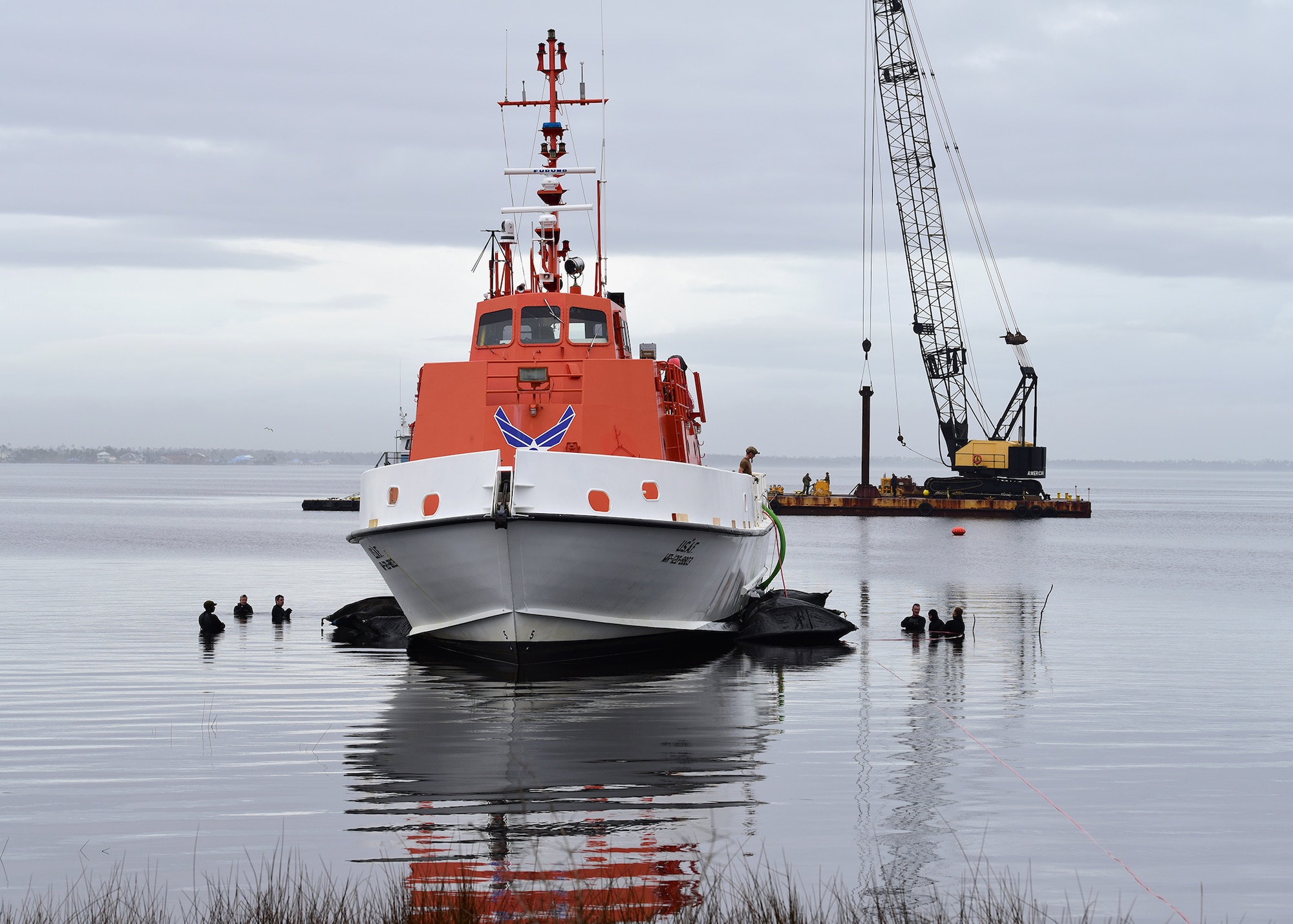 A U.S. Air Force Missile Retriever Ship sits atop inflatable bladders near Tyndall Air Force Base, Fla., Dec. 14, 2018. Prior to returning to the water, the vessel sat beached due to the strong winds of Hurricane Michael. Sailors from Mobile Diving and Salvage Unit (MDSU) 2, homeported at Joint Expeditionary Base Little Creek-Ft. Story, partnered with Tyndall personnel and contractors to return the vessel to the water. (U.S. Air Force photo by Senior Airman Isaiah J. Soliz)