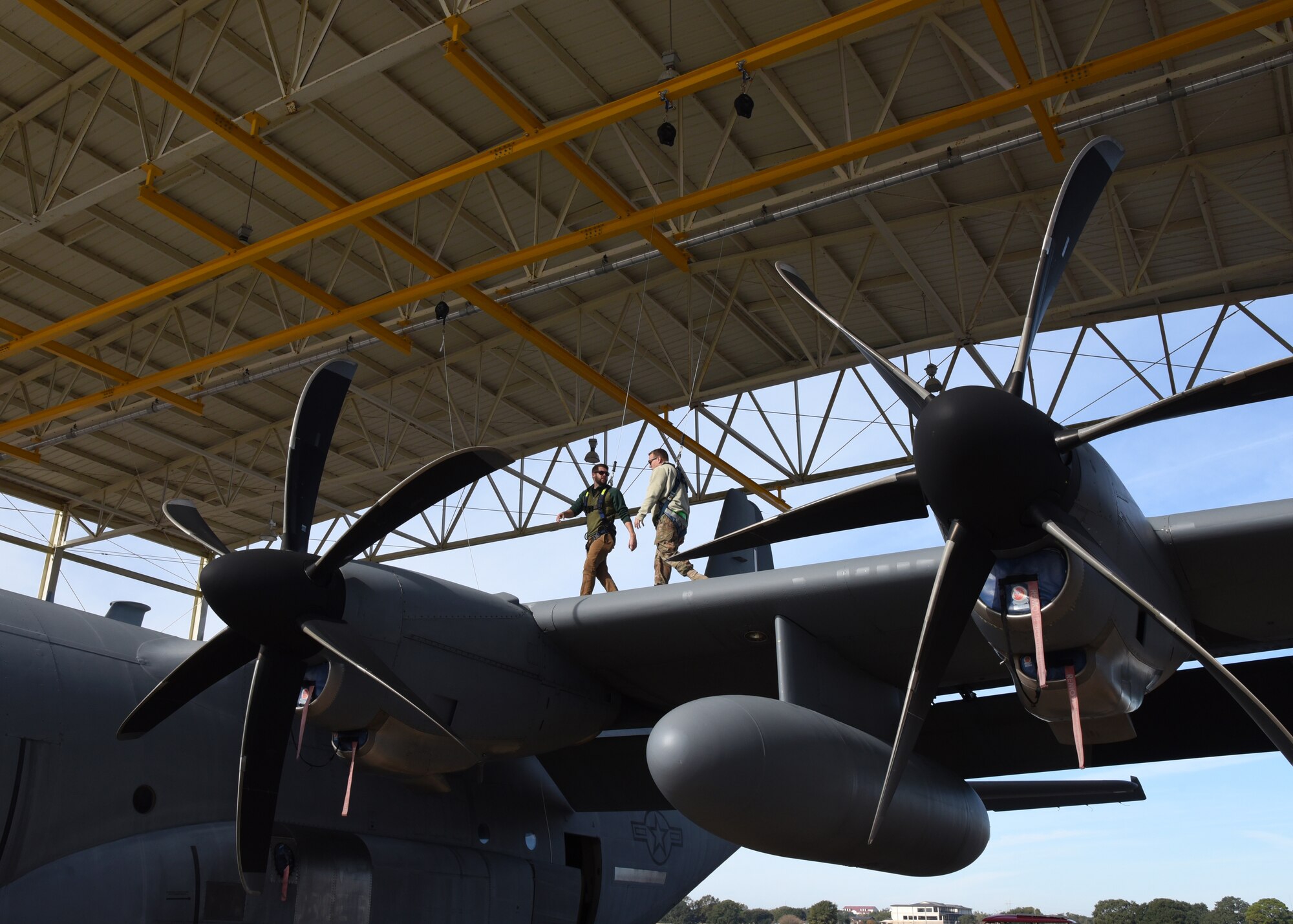 Jordan Moon, on the left, Webb Rite Safety, trains Tech. Sgt. Nathan Collins, 803rd Aircraft Maintenance Squadron crewchief, on how to use the safety harness feature in the Wash Rack at Keesler Air Force Base, Miss. The 403rd Wing replaced the safety harness feature in the Wash Rack Dec. 10-13, 2018. The C-130J Super Hercules aircraft are washed every 30 days and with the new safety feature contractors and military personnel will be able to wash the aircraft more thoroughly as well as safely. (U.S. Air Force photo by Maj. Marnee A.C. Losurdo)