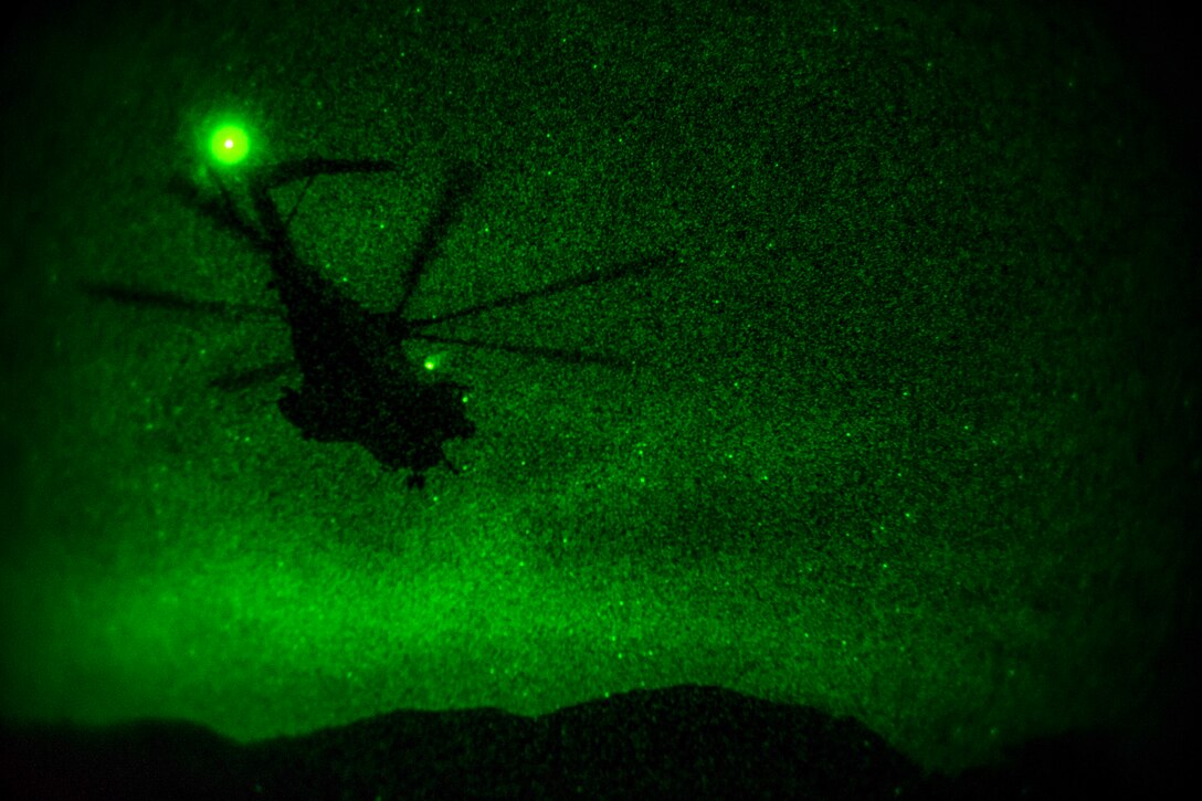 A helicopter takes off at night.