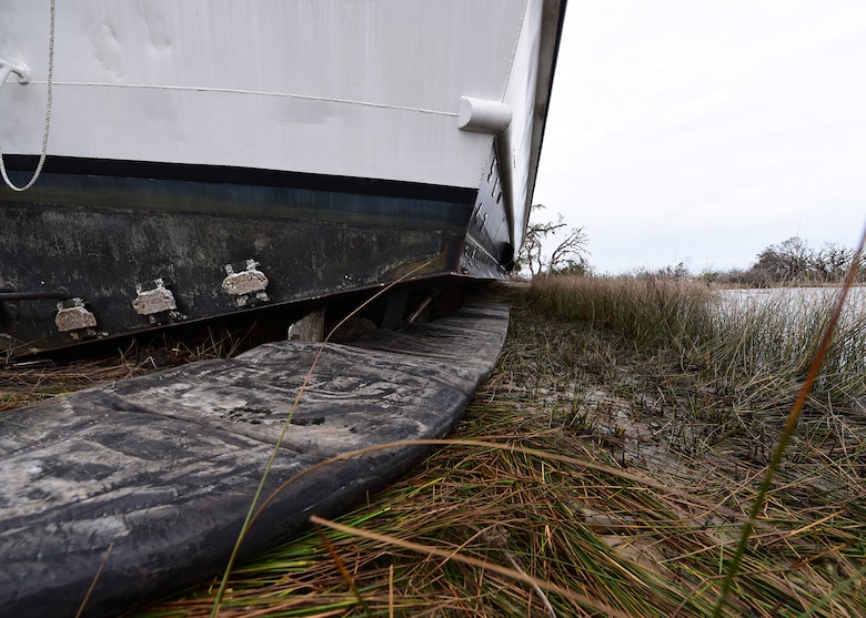 An inflatable bladder sits beneath the hull of a beached U.S. Air Force Missile Retriever Ship at Tyndall Air Force Base, Fla., Dec. 13, 2018. The vessel ran aground during the powerful winds brought on by Hurricane Michael. (U.S. Air Force photo by Senior Airman Isaiah J. Soliz)