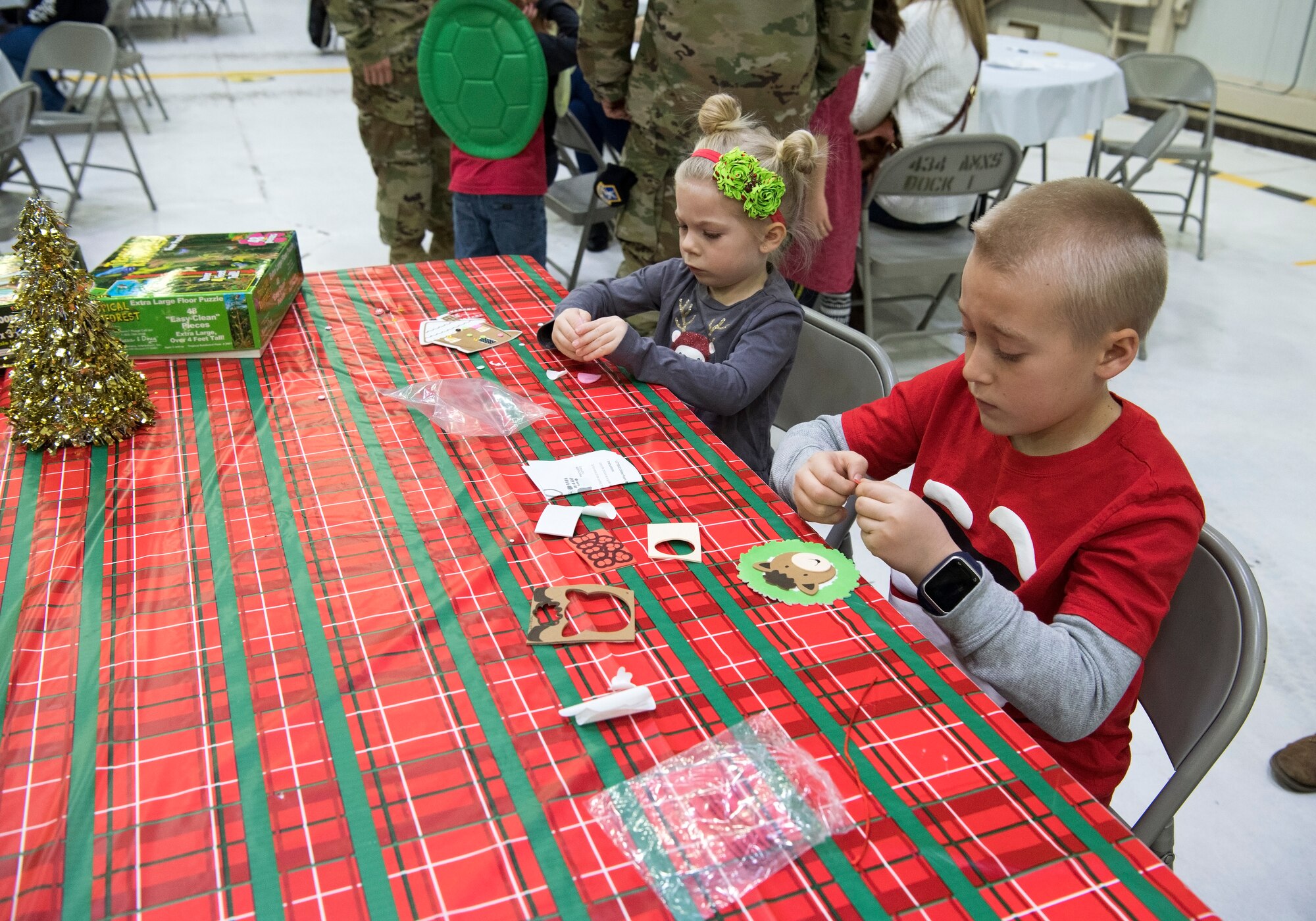 Aubriella and Mason Massey get crafty during a Christmas celebration. Grissom recently help a children’s Christmas celebration in Dock 1 Dec. 1 here. (U.S. Air Force photo/Tech. Sgt. Jami K. Lancette)
