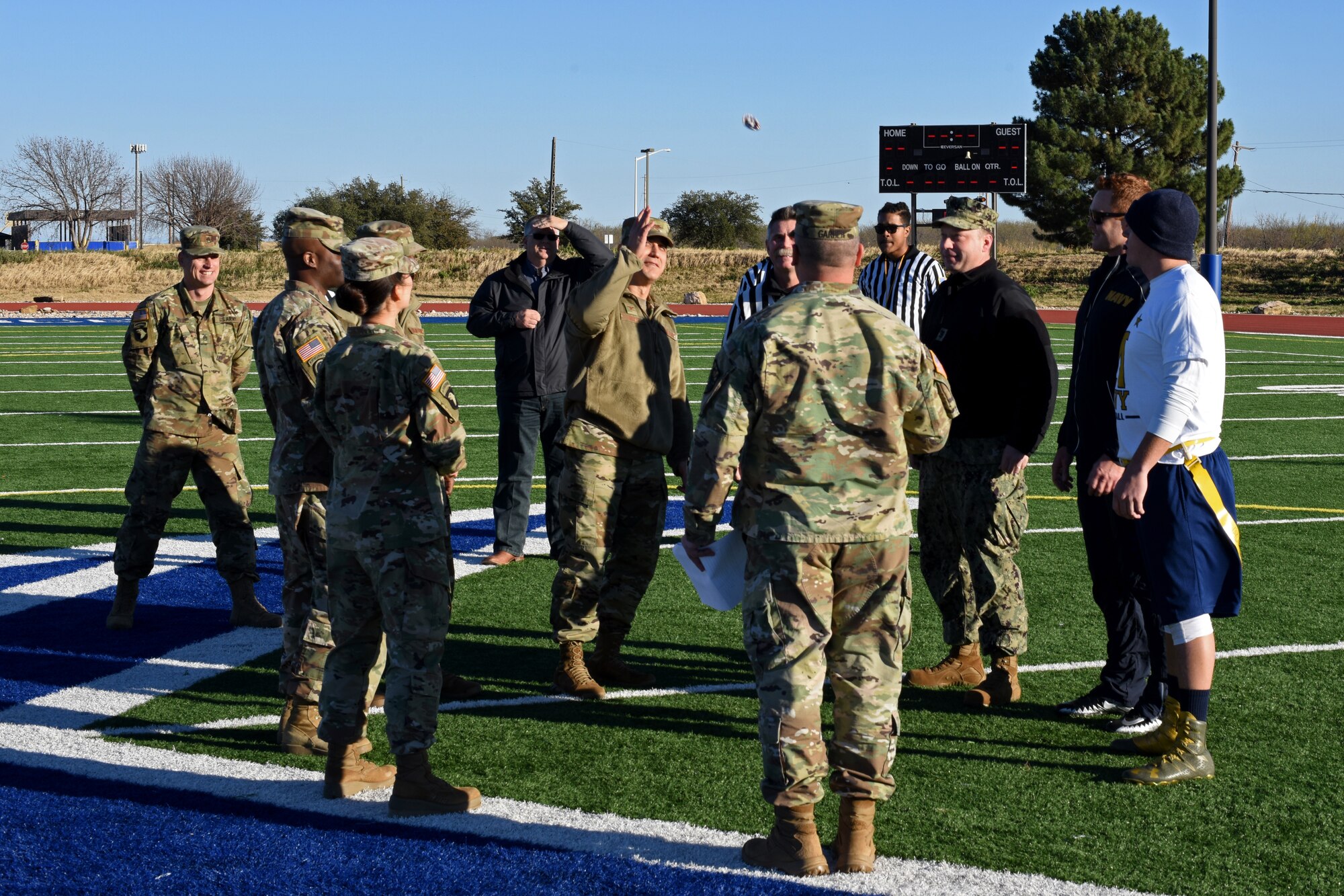 U.S. Air Force Col. Ricky Mills, 17th Training Wing commander, flips the coin to decide who gets the ball first during the Army-Navy game at the Mathis Fitness Center field on Goodfellow Air Force, Texas, Dec. 14, 2018. This year marked the 14th year that the Army-Navy game has taken place on Goodfellow. (U.S. Air Force photo by Airman 1st Class Zachary Chapman/Released)