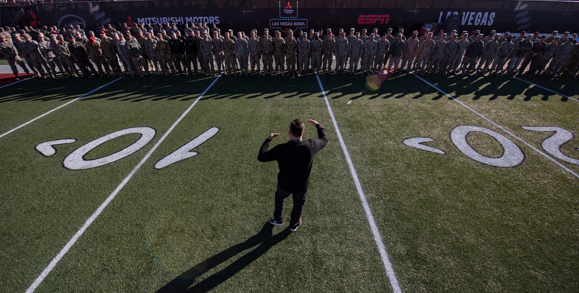 Rob Harden, 2018 Las Vegas Bowl flag team lead, speaks to Airmen assigned to Nellis and Creech Air Force bases, Nevada, before the opening ceremony at Sam Boyd Stadium in Las Vegas, Dec. 15, 2018. More than 200 Airmen volunteered to present a football field-sized American flag during the national anthem. (U.S. Air Force photo by Senior Airman Andrew D. Sarver)