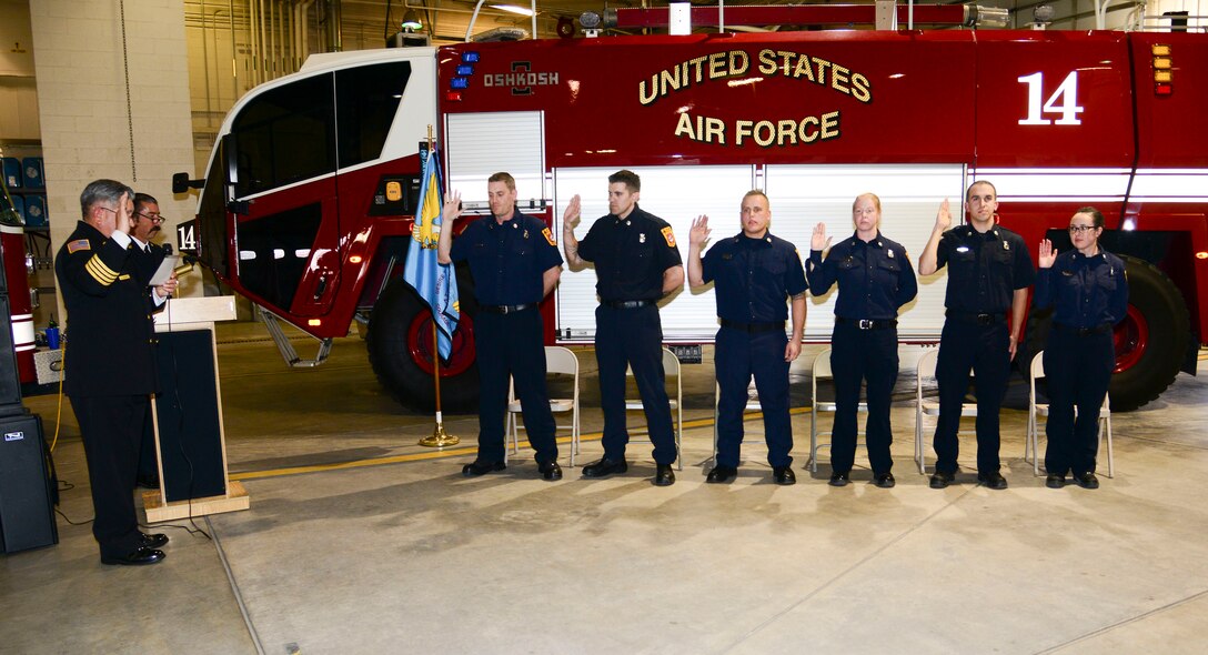Department Deputy Chief Jaime Jimenez swore-in six new firefighters from left to right Thomas Fitzpatrick, Joshua Dunn, Christopher Davis, Kari Kline, Caleb Linville and Katelynn Montoya. in a ceremony here Dec. 14. Kirtland AFB Fire and Emergency Services training academy graduates underwent eight weeks of training completing the first iteration conducted at Kirtland for 14 years. (U.S. Air Force photo by Jessie Perkins)