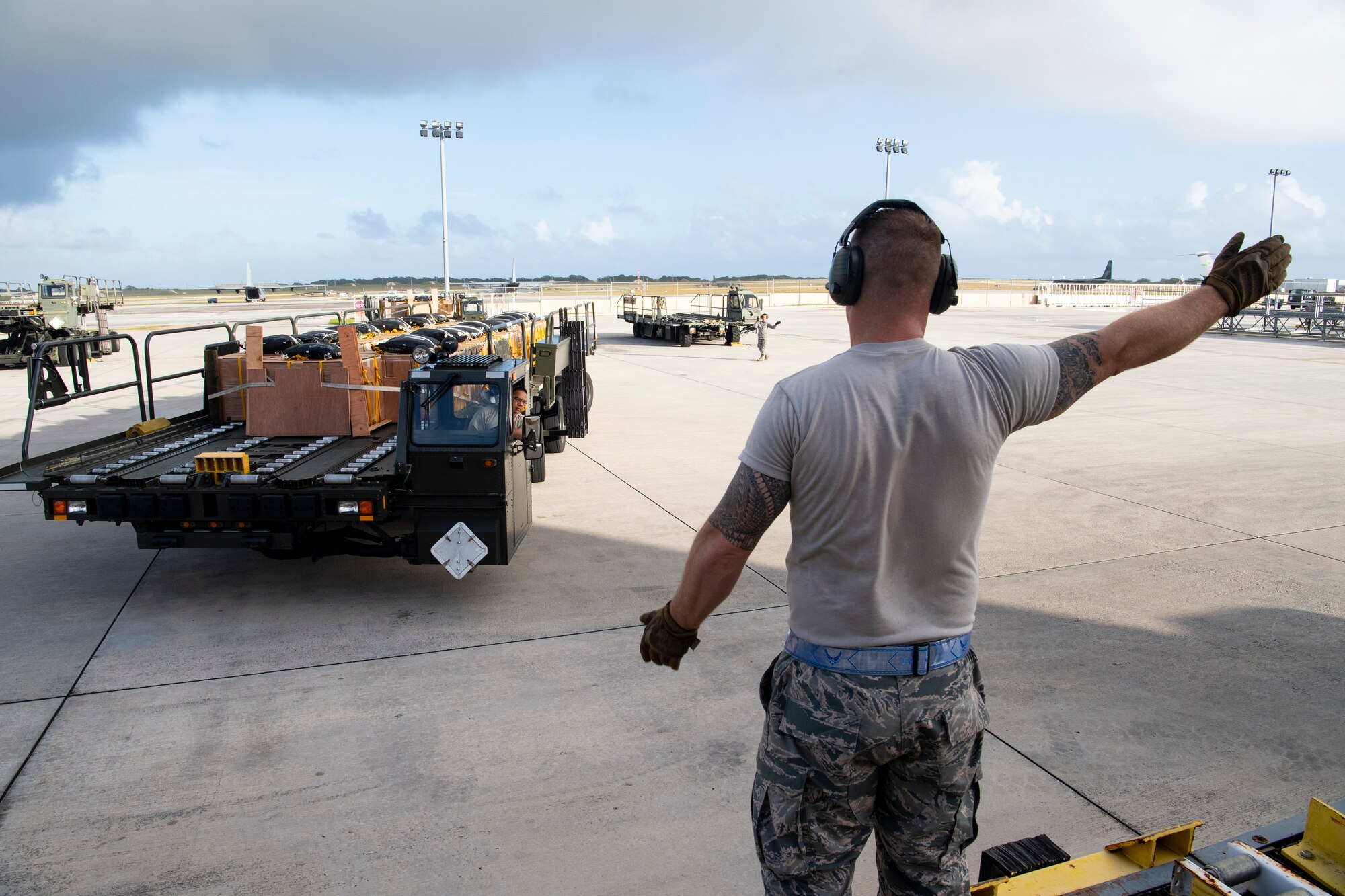 U.S. Air Force Airman Willy Hong (left to right) and Master Sgt. Rene Molinos, both air transportation specialist with the U.S. Air Force Reserve’s 44th Aerial Port Squadron, preposition airdrop bundles ready for transportation out to awaiting aircraft Dec 9, 2018, during Operation Christmas Drop at Andersen Air Force Base, Guam. Operation Christmas Drop is a U.S. Air Force-led trilateral training event that includes air support from the Japanese Air Self Defense Force and Royal Australian Air Force to airdrop supplies to the Commonwealth of the Northern Marianas, Federated States of Micronesia, and the Republic of Palau. (U.S. Air Force photo by Jerry R. Bynum)