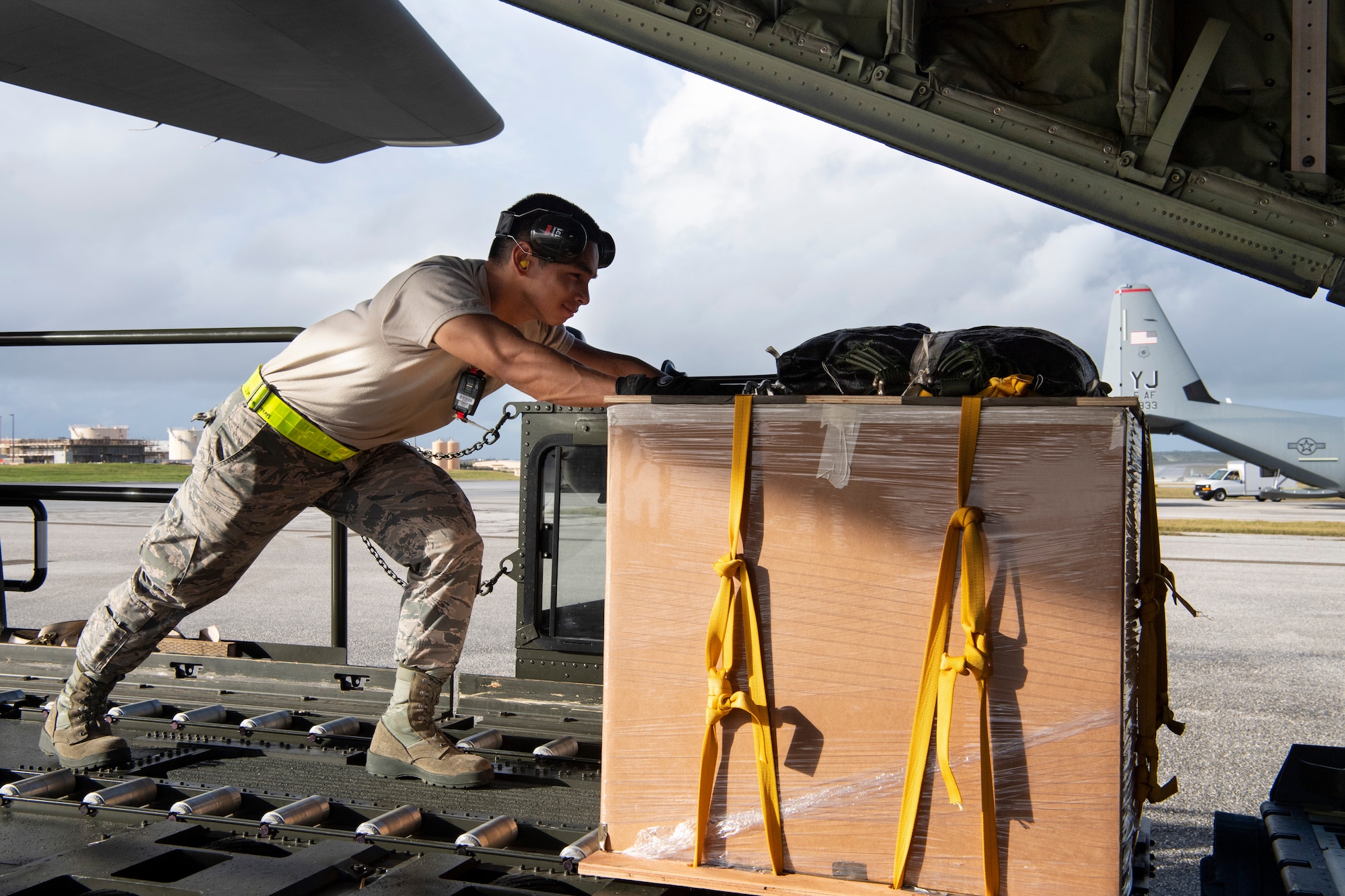 U.S. Air Force Airman 1st Class Joshua San Agustin, an air transportation specialist with the U.S. Air Force Reserve’s 44th Aerial Port Squadron, loads a U.S. Air Force C-130J Hercules Dec. 11, 2018, with an airdrop bundle during Operation Christmas Drop at Andersen Air Force Base, Guam. Operation Christmas Drop is a U.S. Air Force-led trilateral training event that includes air support from the Japanese Air Self Defense Force and Royal Australian Air Force to airdrop supplies to the Commonwealth of the Northern Marianas, Federated States of Micronesia, and the Republic of Palau. (U.S. Air Force photo by Jerry R. Bynum)