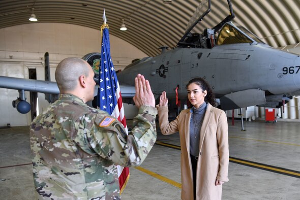 Samantha De La Rosa, right, recites the oath of enlistment with her father, U.S. Army Maj. Rudy De La Rosa, 8th Army director of policies, programs and awards, at Osan Air Base, Republic of Korea, Dec. 10, 2018. Samantha is a fourth generation service member in her family, ranging back to her great grandfather who was in the U.S. Navy during World War II. (U.S. Air Force photo by Senior Airman Kelsey Tucker)