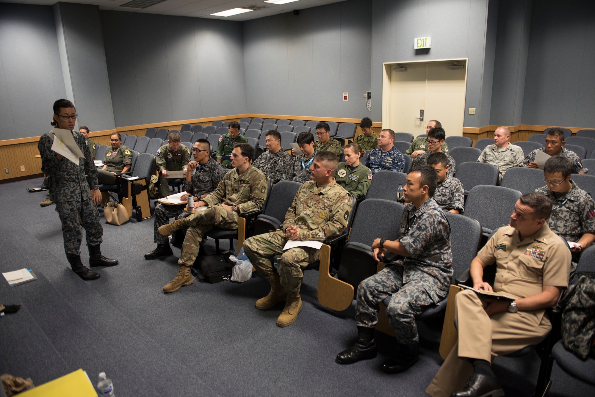 A member of the Japan Air Self-Defense Force speaks to U.S. military and other JASDF members during the Alliance Coordination Mechanism Sept. 26, 2018, at Kadena Air Base, Japan. Both countries worked to strengthen cooperation by mutually sharing information and enhancing situational awareness.