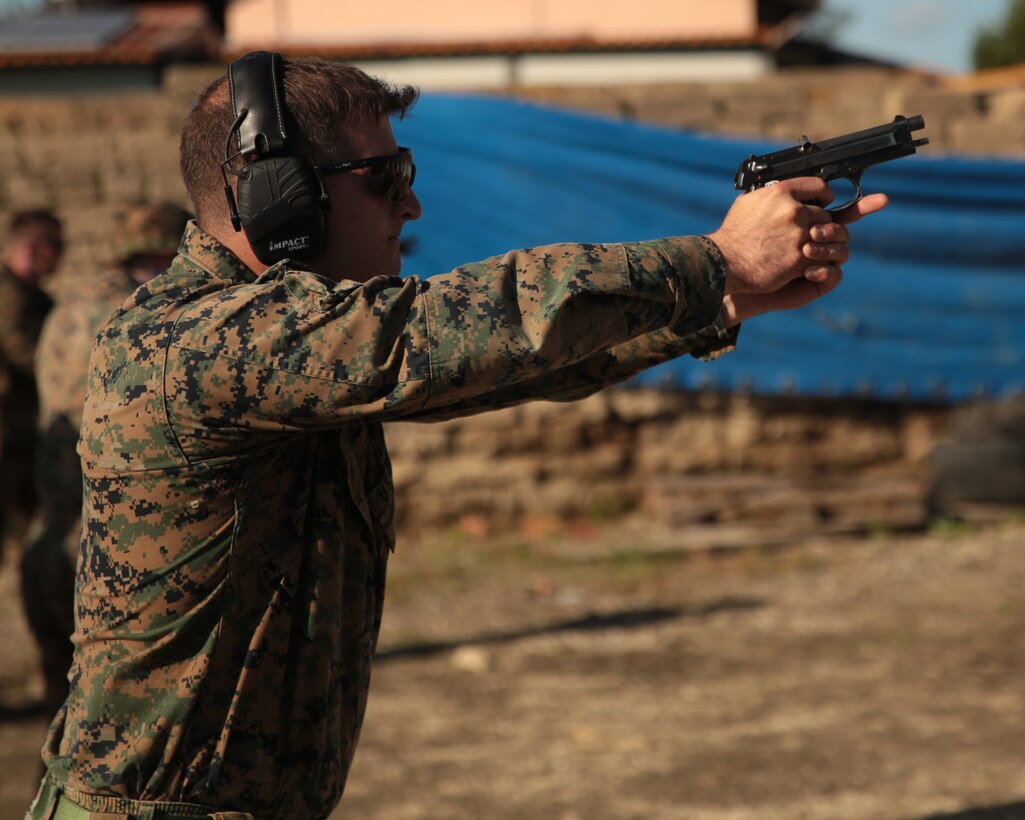 A U.S. Marine with the ground combat element of Special Purpose Marine Air-Ground Task Force- Crisis Response- Africa (SPMAGTF-CR-AF) 19.1 qualifies on the Beretta M9 pistol at Etna Range, Sicily, Italy, Nov. 22, 2018. SPMAGTF-CR-AF is deployed to conduct crisis-response and theater-security operations in Europe and Africa. (U.S. Marine Corps photo by Cpl. Bethanie Ryan)