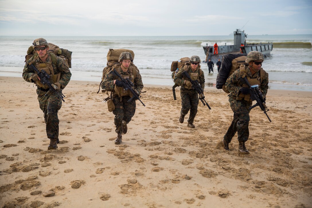 U.S. Marines with Special Purpose Marine Air-Ground Task Force-Crisis Response-Africa sprint to a security position after disembarking a Landing Craft Utility boat during GRUFLEX in Sierra De Retin, Spain, Nov. 23, 2018. GRUFLEX is a multinational amphibious exercise led by the Spanish navy that focuses on enhancing multilateral tactics and building partner relations through shared training events. SPMAGTF-CR-AF is a rotational force deployed to conduct crisis-response and theater-security operations in Europe and Africa. (U.S. Marine Corps photo by Sgt. Katelyn Hunter)