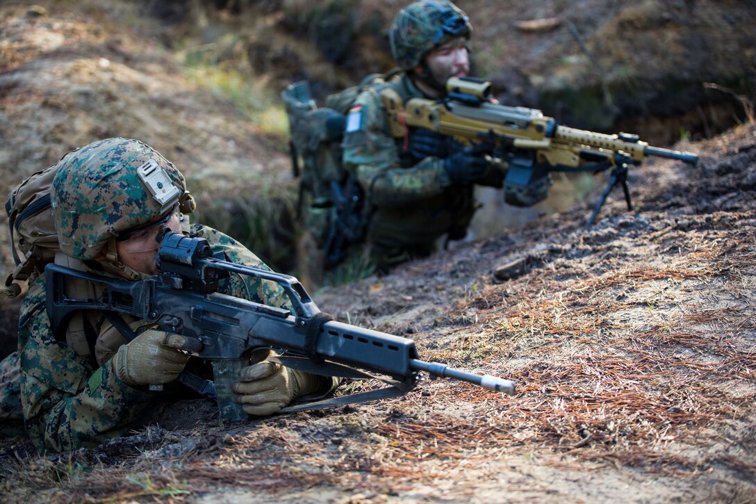 A U.S. Marine with Special Purpose Marine Air-Ground Task Force-Crisis Response-Africa and a German soldier set security during a training event in Seedorf, Germany, Dec. 4, 2018.  This event, which focused on infantry tactics and maneuvers, marked the first time U.S. Marines have trained with German Fallschirmjäger Regiment-31. SPMAGTF-CR-AF is a rotational force deployed to conduct crisis-response and theater-security operations in Europe and Africa. (U.S. Marine Corps photo by Sgt. Katelyn Hunter)