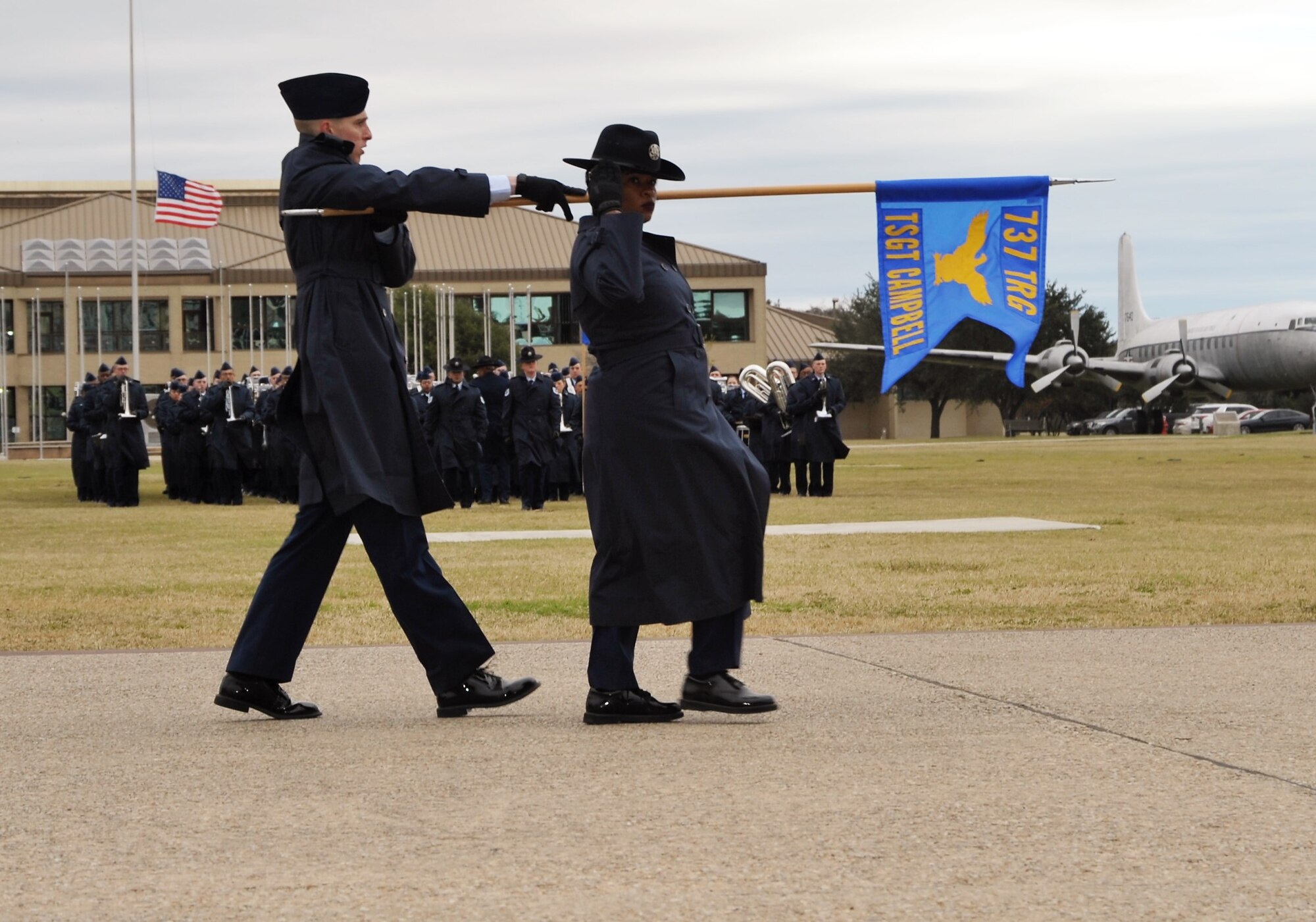 A 433rd Training Squadron basic military training instructor and trainee salute the reviewing official and distinguished guests during the Dec. 14 BMT graduation at Joint Base San Antonio-Lackland, Texas. This flight was named in honor of fallen Reserve Citizen Airmen Explosive Ordnance Specialist Tech. Sgt. Anthony Campbell.  (U.S. Air Force photo by Debbie Gildea)