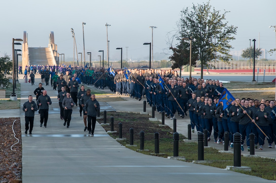 433rd Training Squadron military training instructors (left) call out cadence and encourage their trainees (right) during the pre-basic military training graduation Airmen’s run at Joint Base San Antonio-Lackland, Texas Dec. 13. (U.S. Air Force photo by Johnny Saldivar)