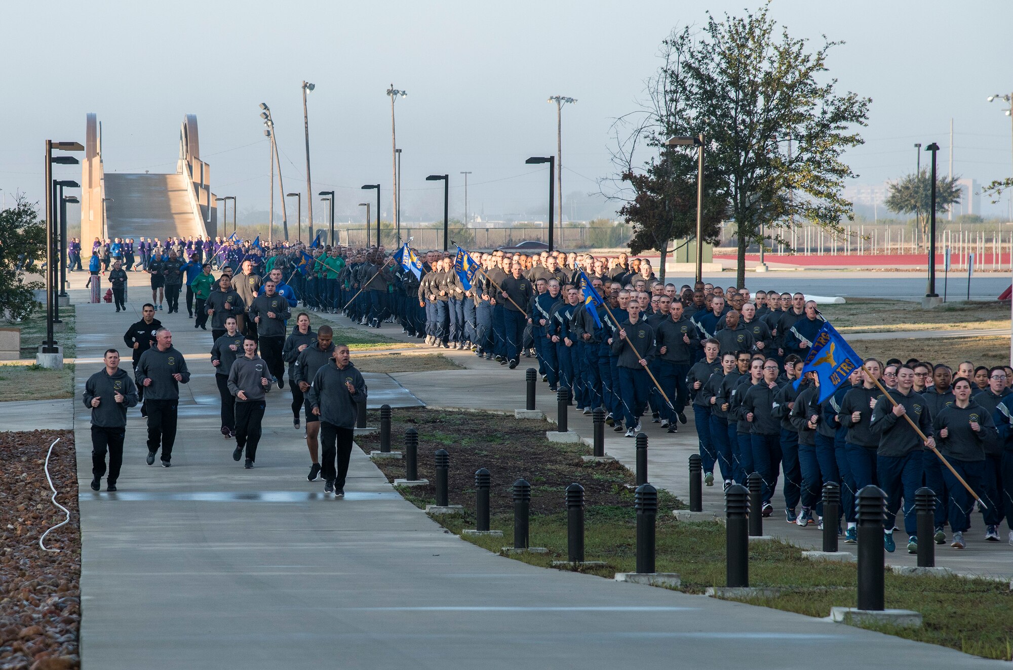 433rd Training Squadron military training instructors (left) call out cadence and encourage their trainees (right) during the pre-basic military training graduation Airmen’s run at Joint Base San Antonio-Lackland, Texas Dec. 13. (U.S. Air Force photo by Johnny Saldivar)