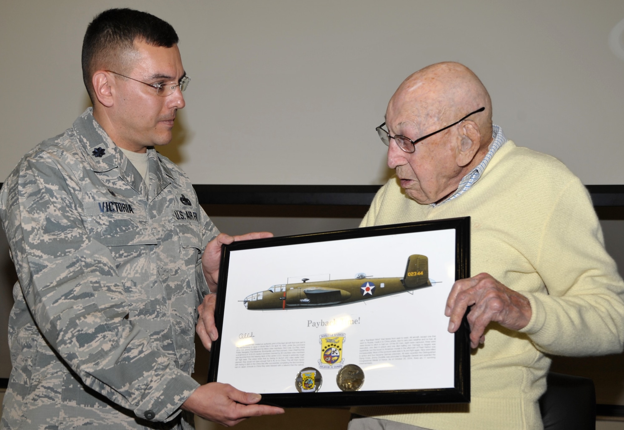 Retired Lt. Col. Dick Cole, the last living member of the World War II Doolittle Raiders was a special guest of the 433rd Training Squadron during basic military training graduation week activities. Following a question and answer session at Joint Base San Antonio-Lackland, Texas Dec. 13, Cole presented 433rd TRS Commander Lt. Col. Christopher Victoria with a memento to hang in the squadron and remind members of the WWII heroes for whom the group was named 433rd “Raiders.” (U.S. Air Force photo by Debbie Gildea)