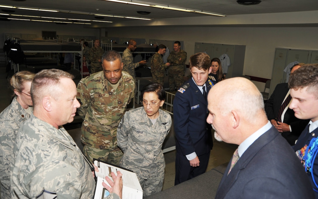 Master Sgt. Robert Elliott, 433rd Training Squadron military training instructor recruiter, tours guests through a basic military training flight dormitory following a flight dedication ceremony held Dec. 13 at Joint Base San Antonio-Lackland, Texas. Guests included senior Air Force Reserve leaders, family members of the fallen Airmen and guests from the local Civil Air Patrol.  The dedication ceremony honored Chief Master Sgt. Ericka Kelly, command chief for Air Force Reserve Command, and three fallen Reserve Citizen Airmen killed in the line of duty, for whom the flights were named. Basic military training flights are traditionally dedicated to enlisted Airmen who have made significant contributions to the nation and the service. (U.S. Air Force photo by Debbie Gildea)