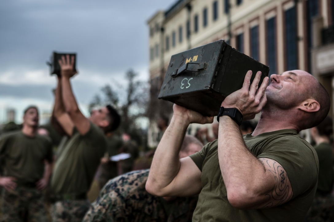 Marines with Marine Forces Reserve perform ammo can lifts during the Combat Fitness Test at Marine Corps Support Facility New Orleans, Dec. 14, 2018. The CFT is an annual fitness assessment comprised of a simulated movement to contact, which is an 880-meter sprint; 2 minutes of 30-pound ammo can lifts, and a maneuver under fire, which is a timed 300-yard shuttle run of combat-related tasks. (U.S. Marine Corps photo by Cpl. Tessa D. Watts)