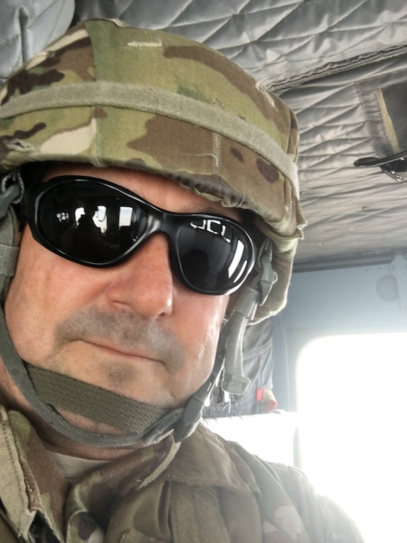 Flying to be with Military and Civilian team members for the Thanksgiving holiday, Drake dons the proper protective gear complete with eyewear and helmet.