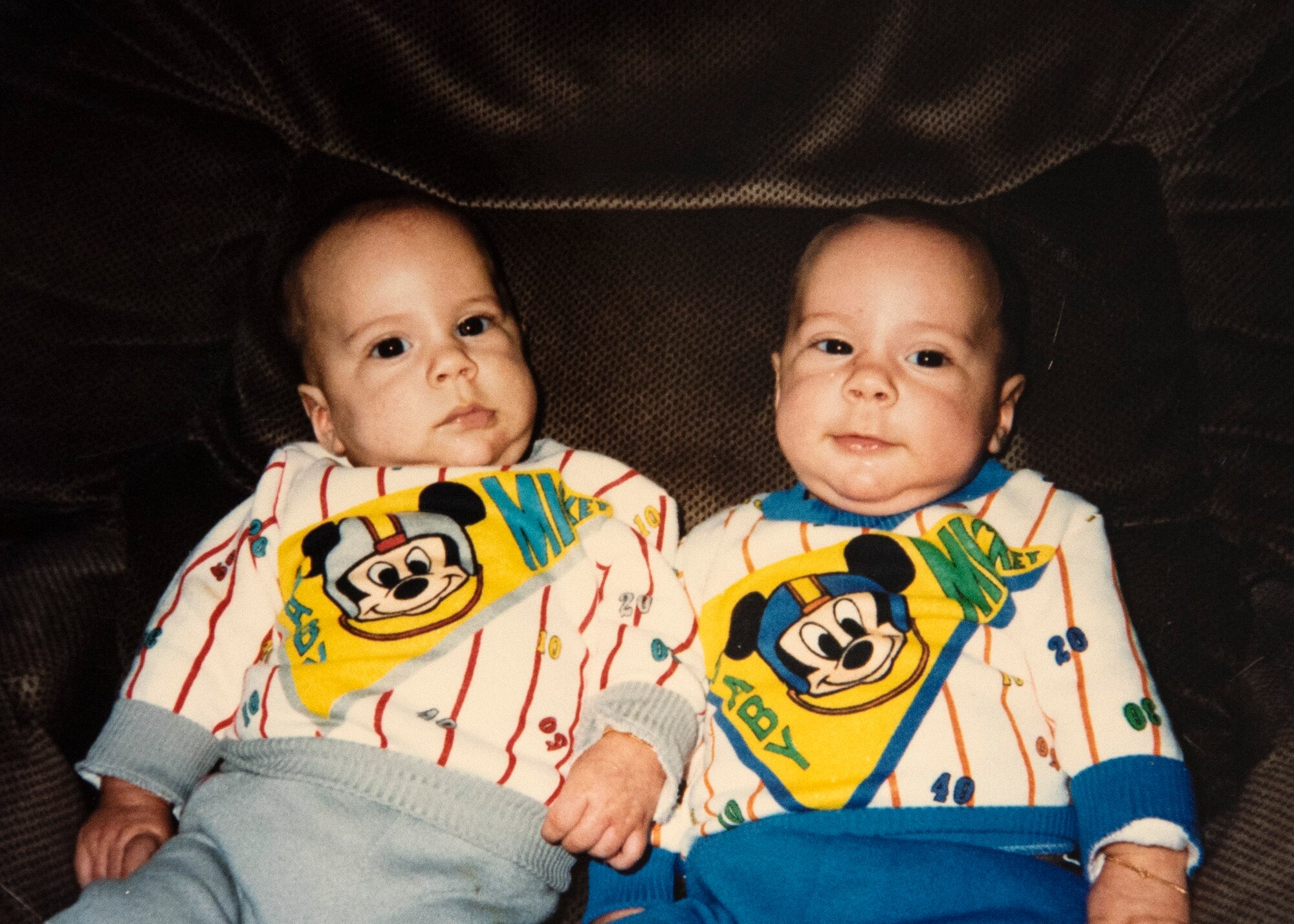 Four-month-old identical twins, Jacob LaFlamme, left, and Zachary LaFlamme, right, pose for a photo. The brothers are now both U.S. Air Force staff sergeants who hold the same job, certifications, and are both stationed at 52nd Fighter Wing geographically separated units. Their mother dressed them in matching outfits until they were two years old. (Courtesy photo provided by Staff Sgt. Zachary LaFlamme)