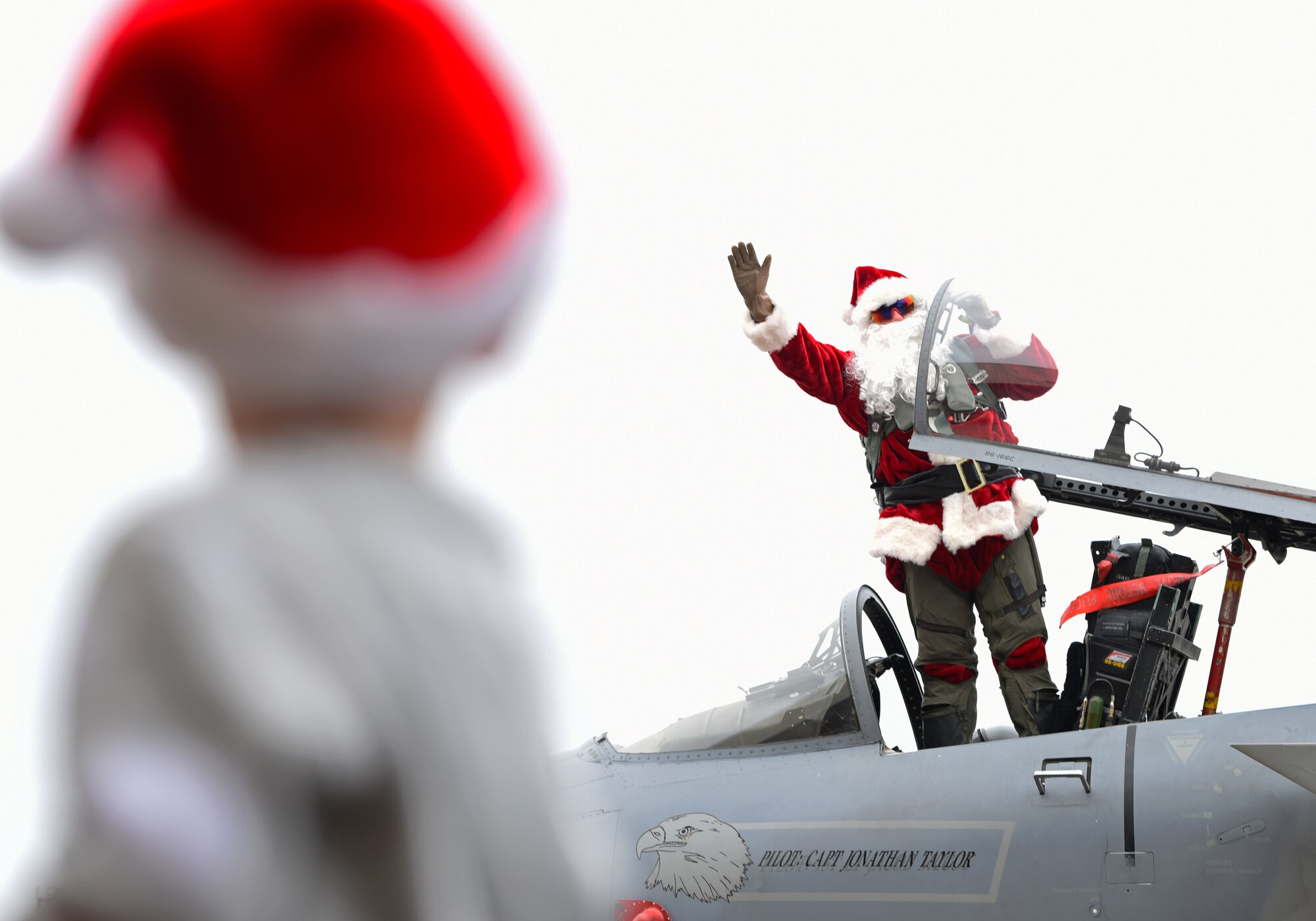 Santa Claus waves at Liberty Wing families during the 48th Fighter Wing Children’s Holiday Party at Royal Air Force Lakenheath, England, Dec. 15, 2018. Party festivities included bouncy houses, holiday crafts, and a photo opportunity with Santa Claus.  (U.S. Air Force photo by Madeline Herzog)