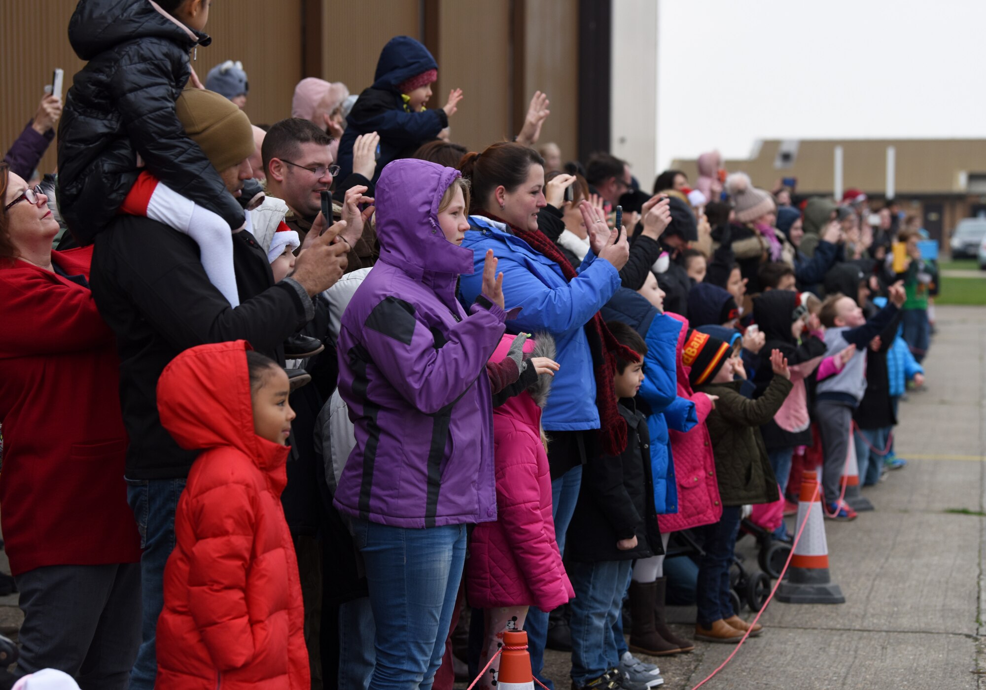 Liberty Wing families await Santa Claus’s arrival during the 48th Fighter Wing Children’s Holiday Party at Royal Air Force Lakenheath, England, Dec. 15, 2018. Various squadrons and volunteers from across the Liberty Wing hosted more than 25 holiday-themed activity tables. (U.S. Air Force photo by Madeline Herzog)