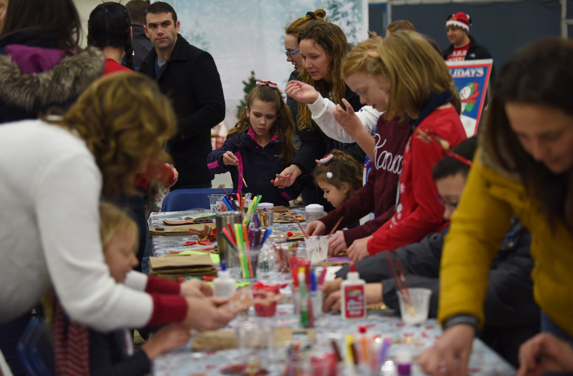 Liberty Wing families participate in holiday crafts during the 48th Fighter Wing Children’s Holiday Party at Royal Air Force Lakenheath, England, Dec. 15, 2018. Party festivities included bouncy houses, holiday crafts, and a photo opportunity with Santa Claus. (U.S. Air Force photo by Madeline Herzog)