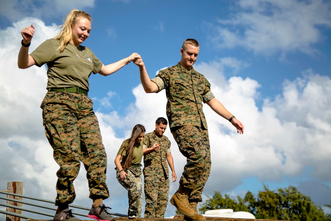 Marine and wife navigate obstacle course.